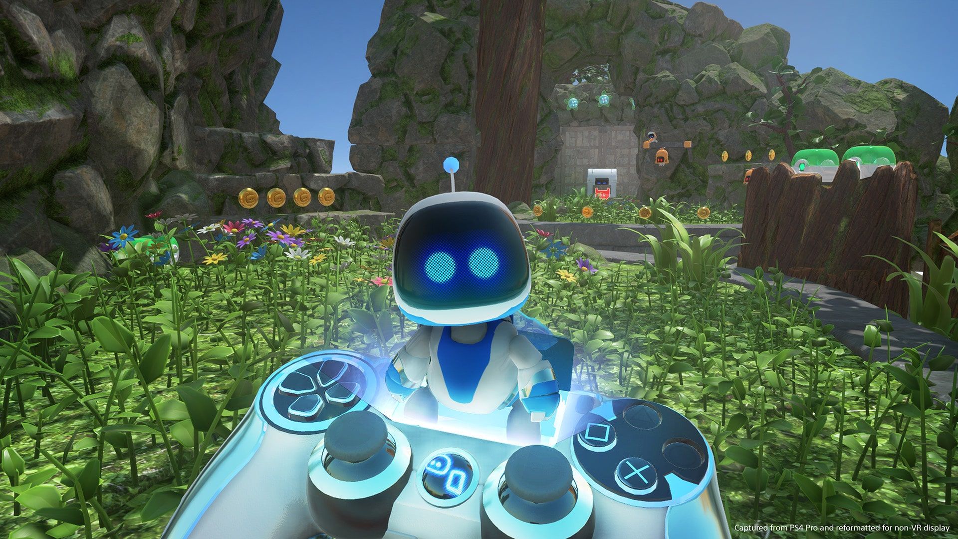 Astro stands on an on-screen DualShock 4 controller with several bots nearby.