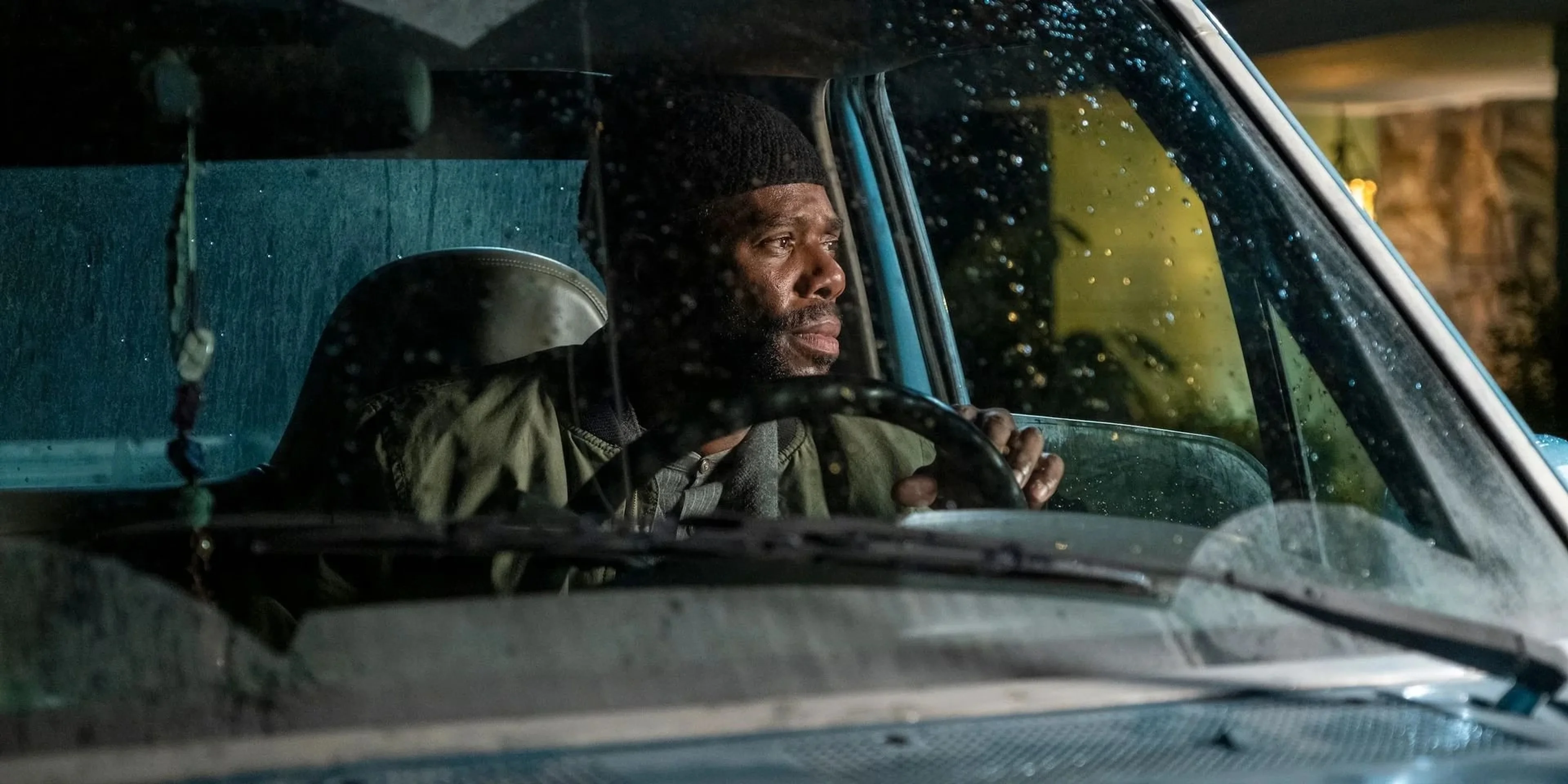Colman Domingo as Ali sits at the wheel of a car in a rain-soaked Euphoria scene.