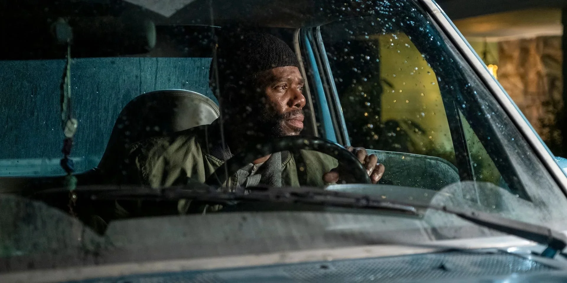 Colman Domingo as Ali sits at the wheel of a car in a rain-soaked Euphoria scene.