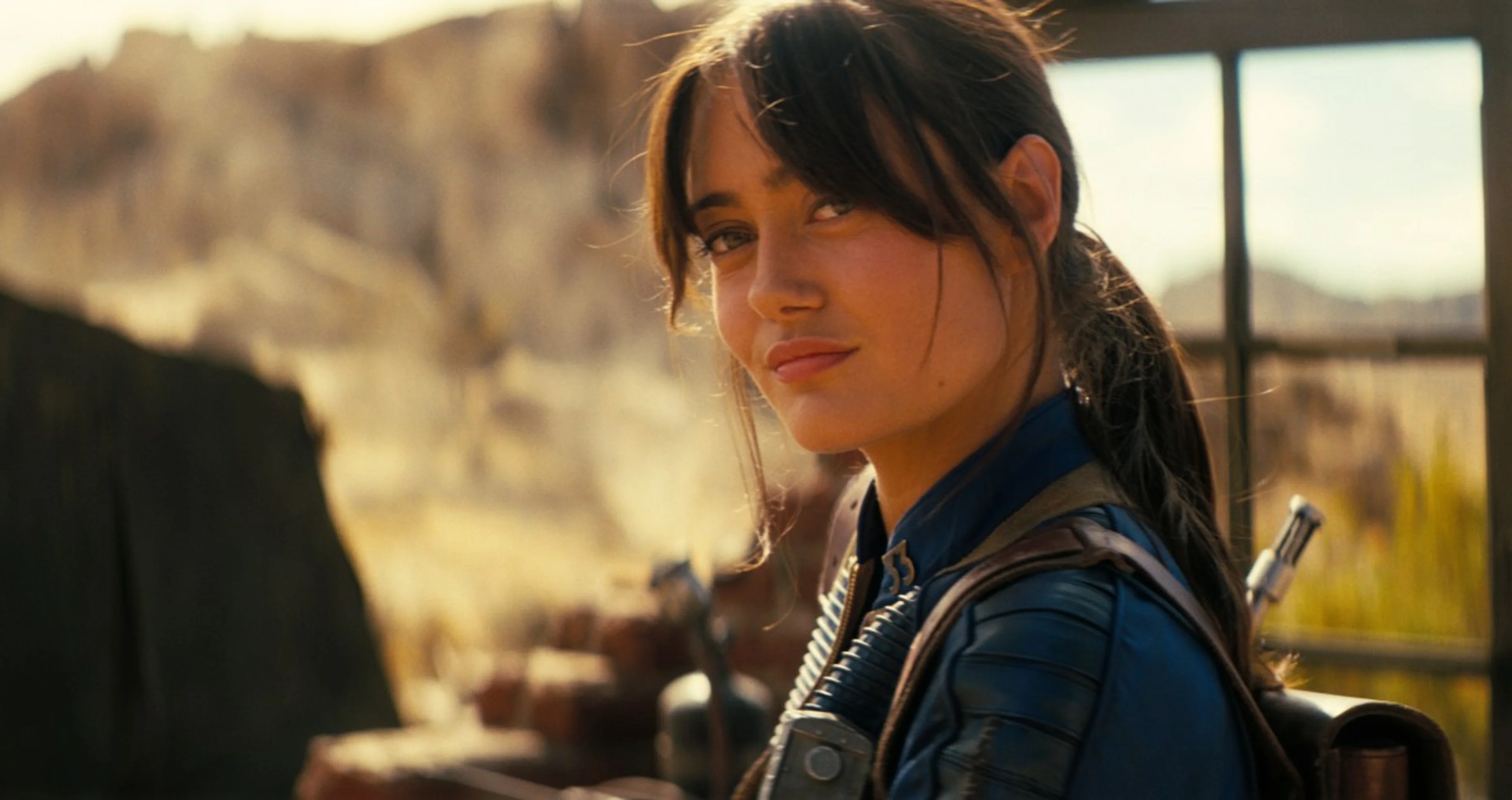 Lucy looks across a desert landscape in the Fallout television series.