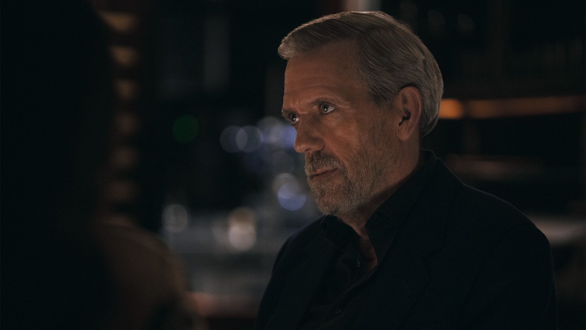 Hugh Laurie as Felix Carmichael in a dark scene from The Wanted Man.