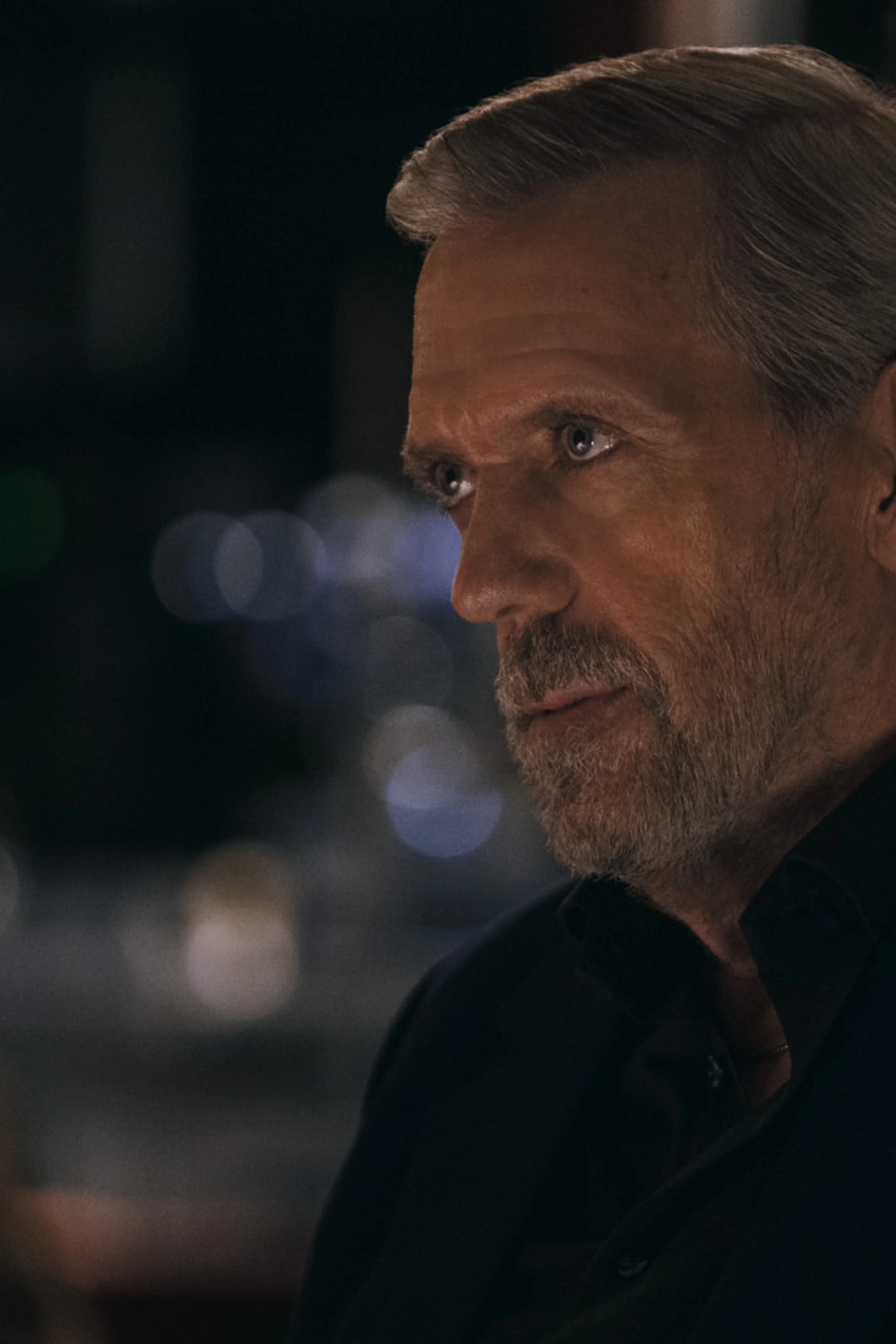Hugh Laurie as Felix Carmichael in a dark scene from The Wanted Man.