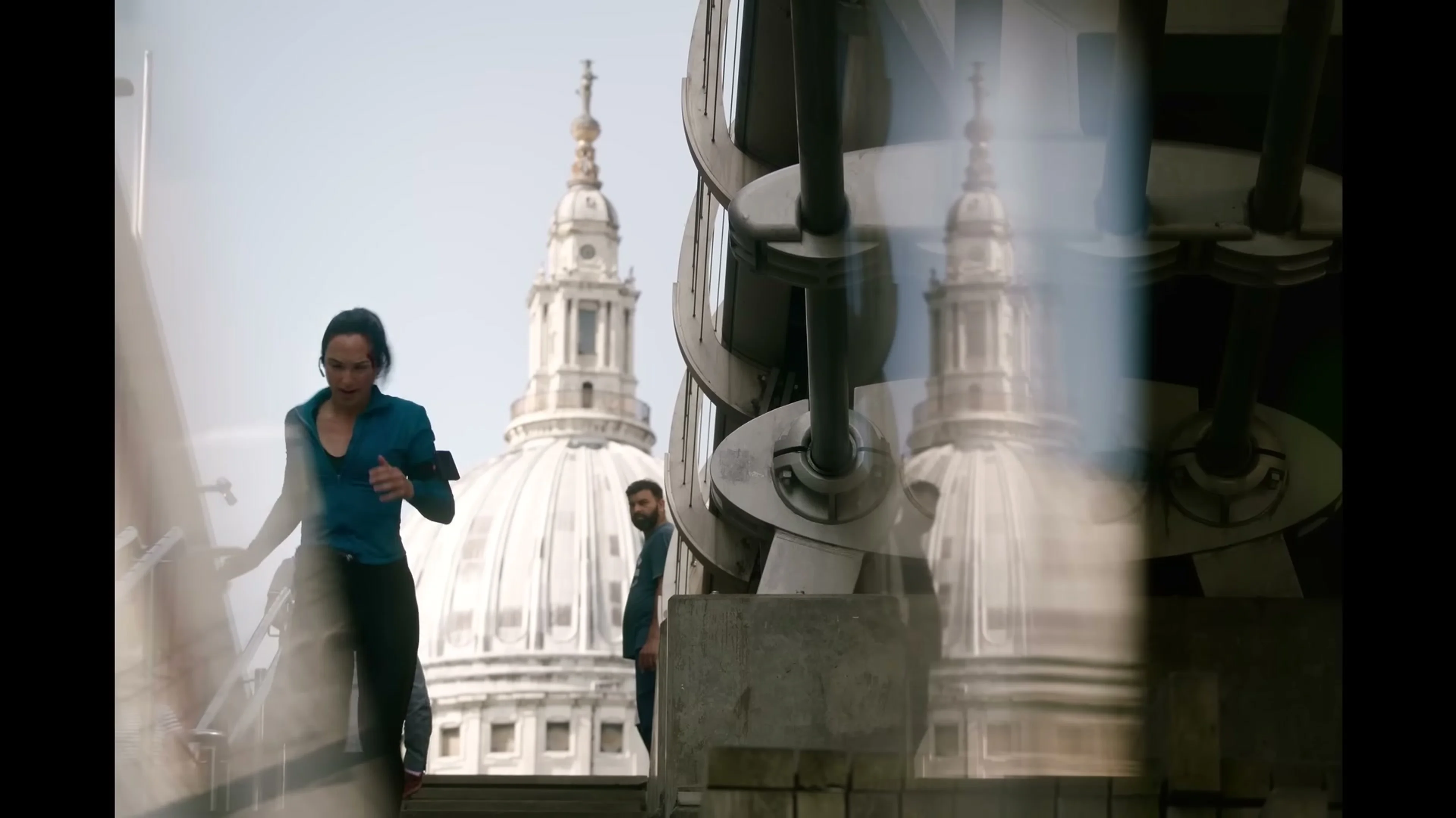 Maia Marten runs along a London street with St Paul’s Cathedral behind her in The Runner.