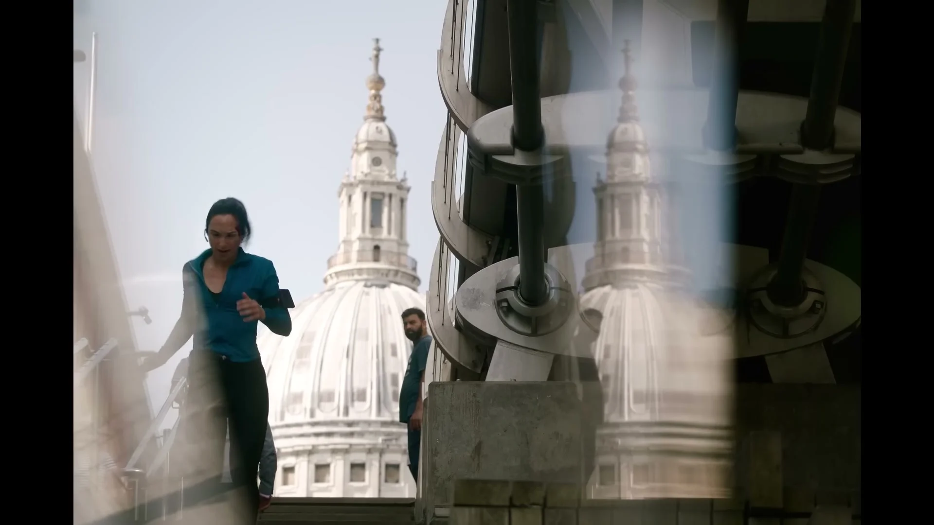 Maia Marten runs along a London street with St Paul’s Cathedral behind her in The Runner.