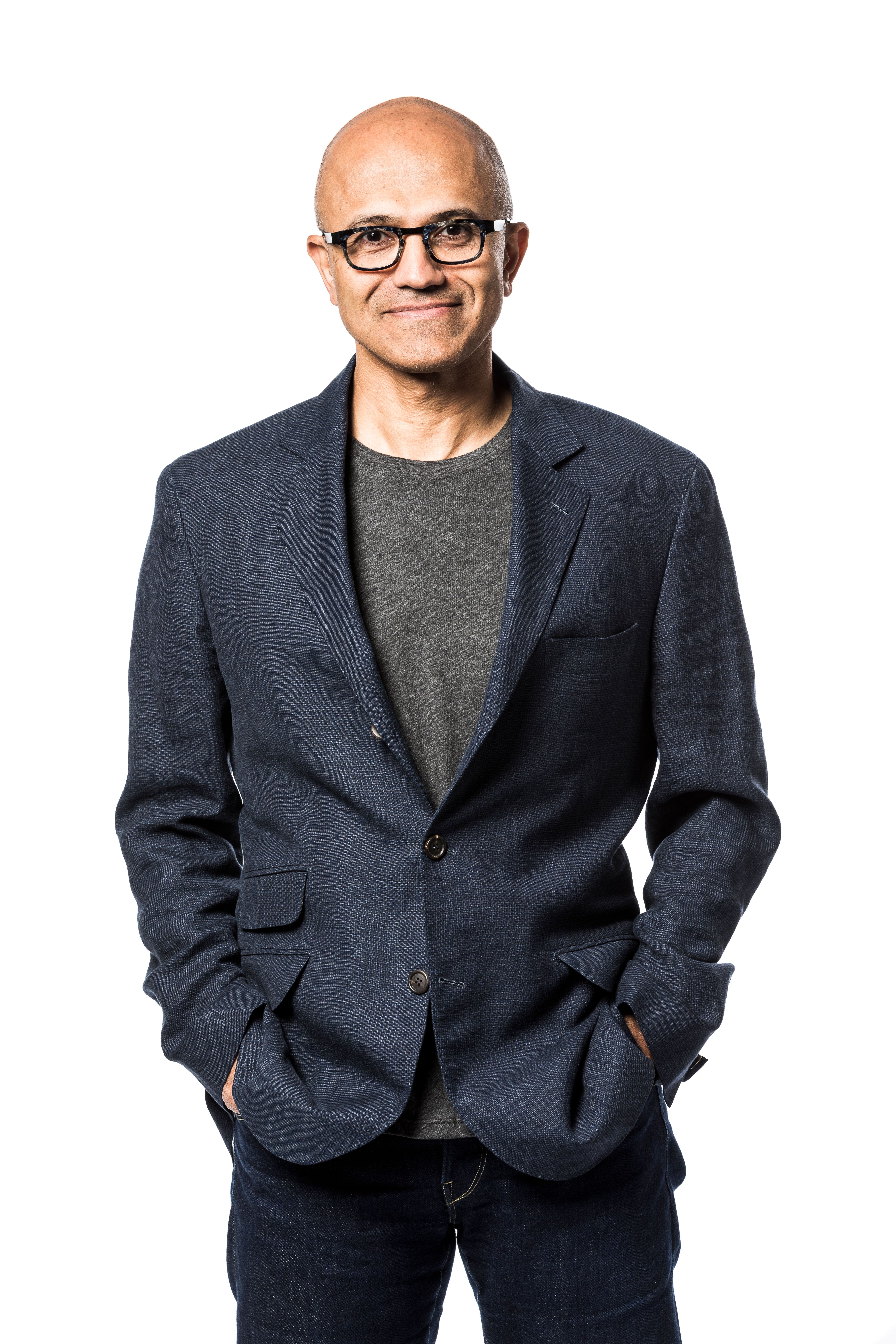 Microsoft CEO Satya Nadella stands against a white background.