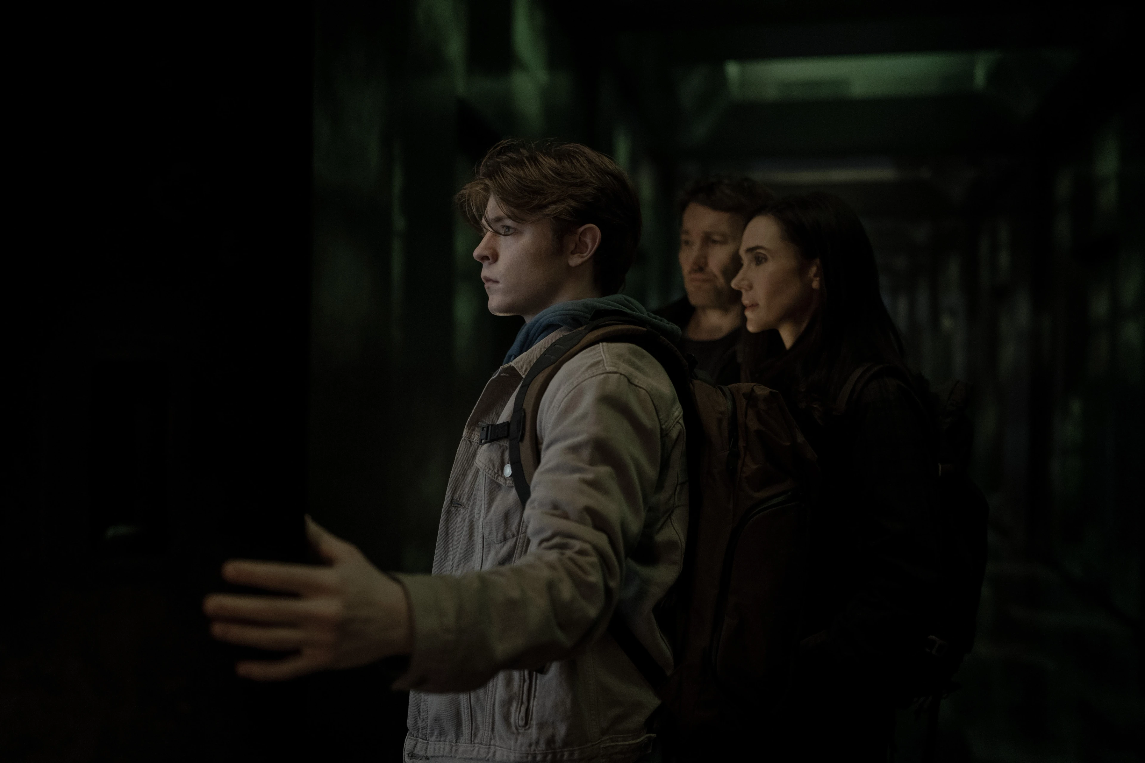 Oakes Fegley stands in front of Joel Edgerton and Jennifer Connelly in Dark Matter Season 2.