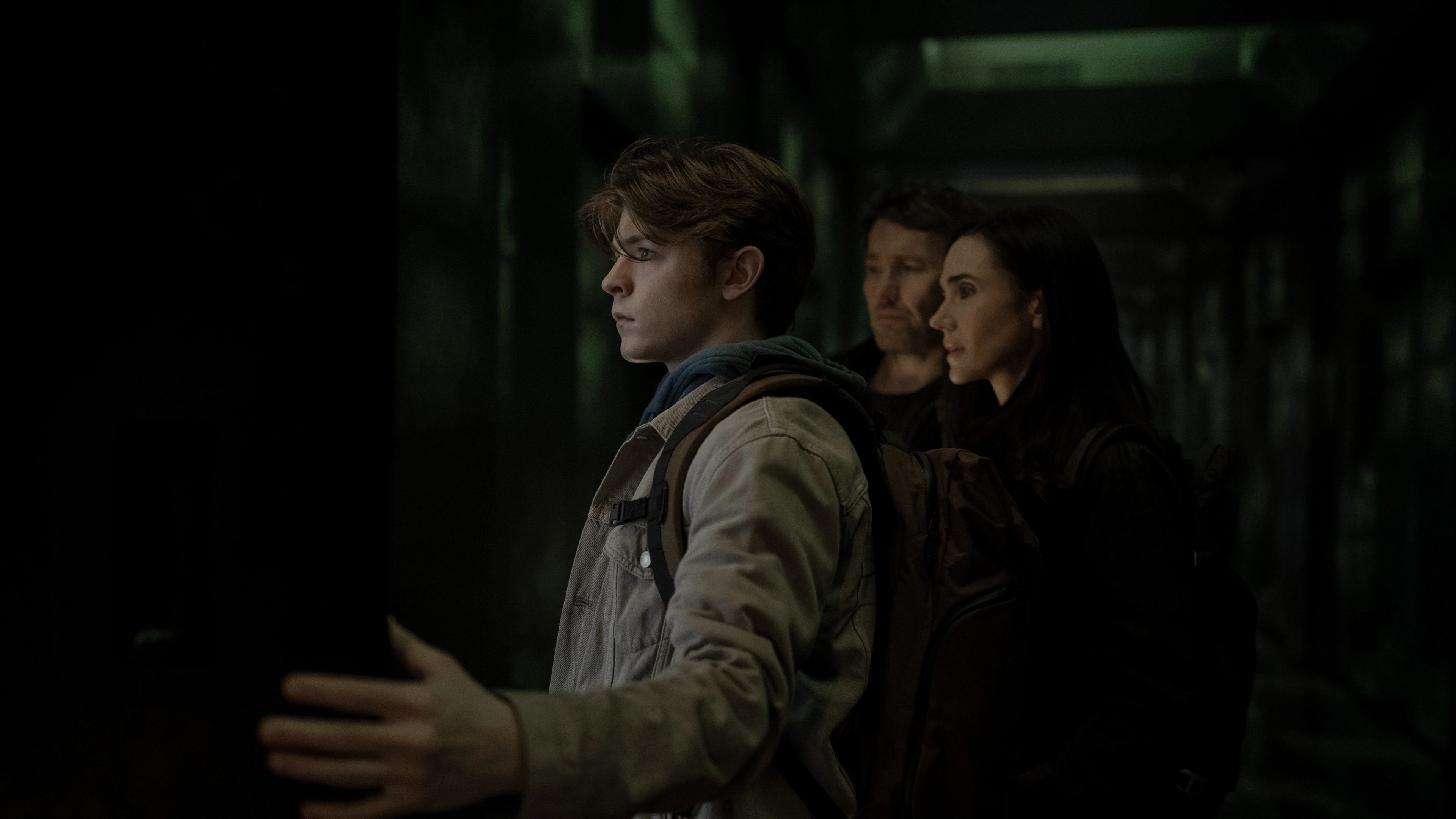 Oakes Fegley stands in front of Joel Edgerton and Jennifer Connelly in Dark Matter Season 2.