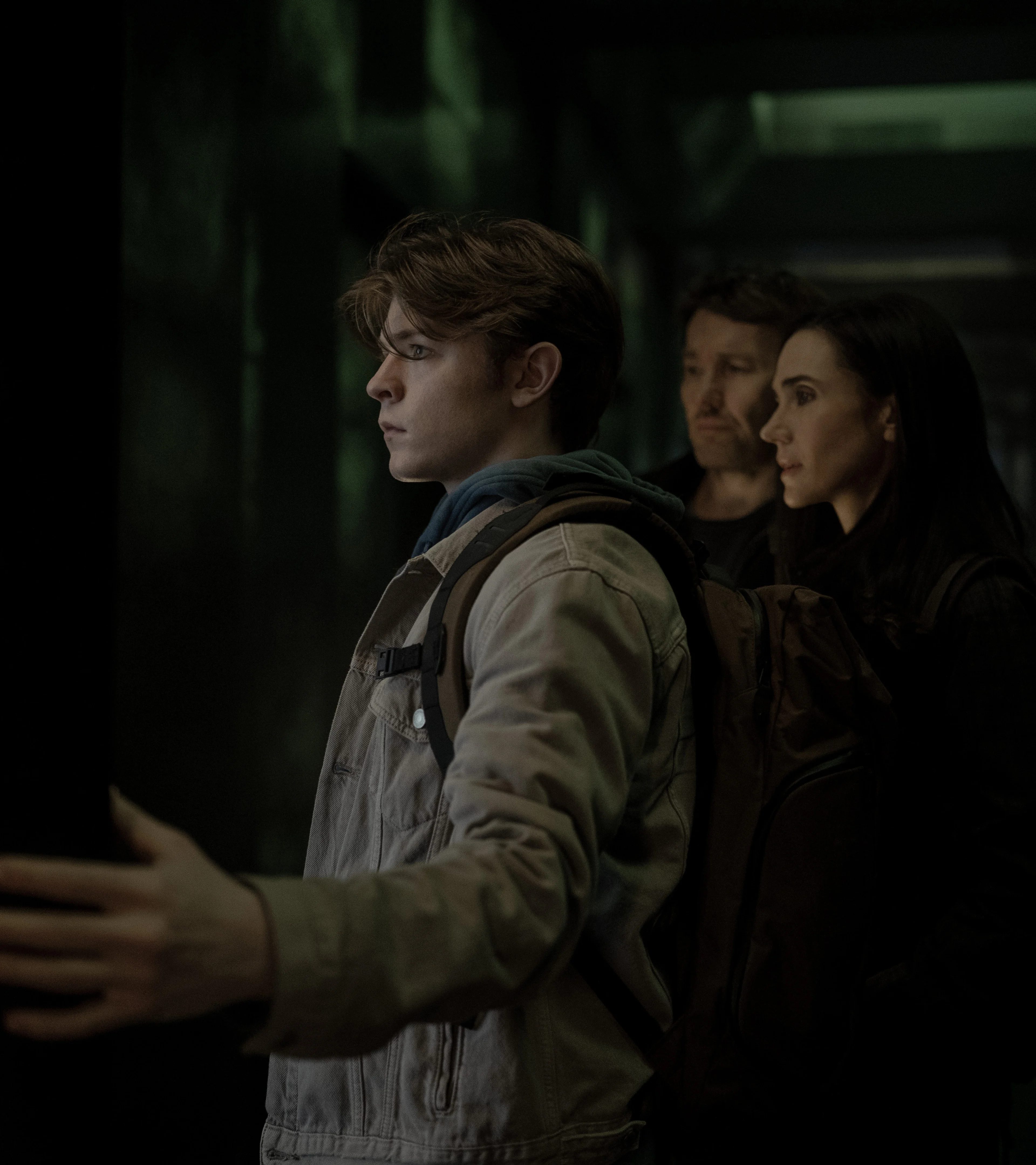 Oakes Fegley stands in front of Joel Edgerton and Jennifer Connelly in Dark Matter Season 2.