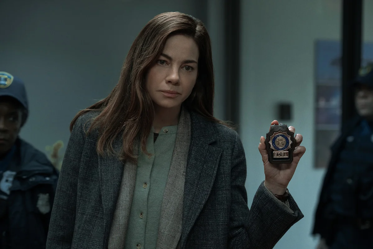 Michelle Monaghan as Detective Amanda Beck holds up her badge in The Whisper Man.