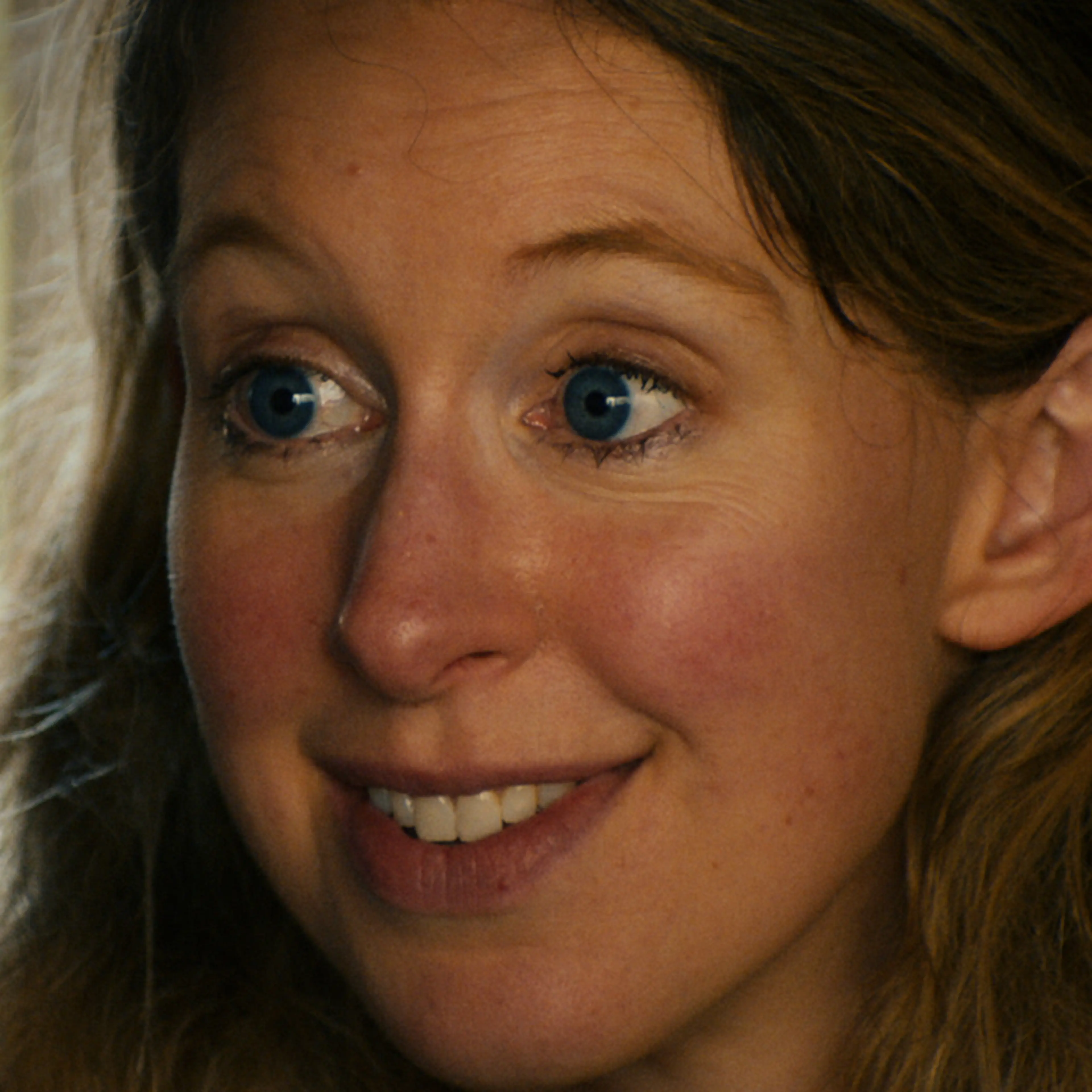 Elizabeth Holmes looks to the side in a vertical still from You Can See Everything.