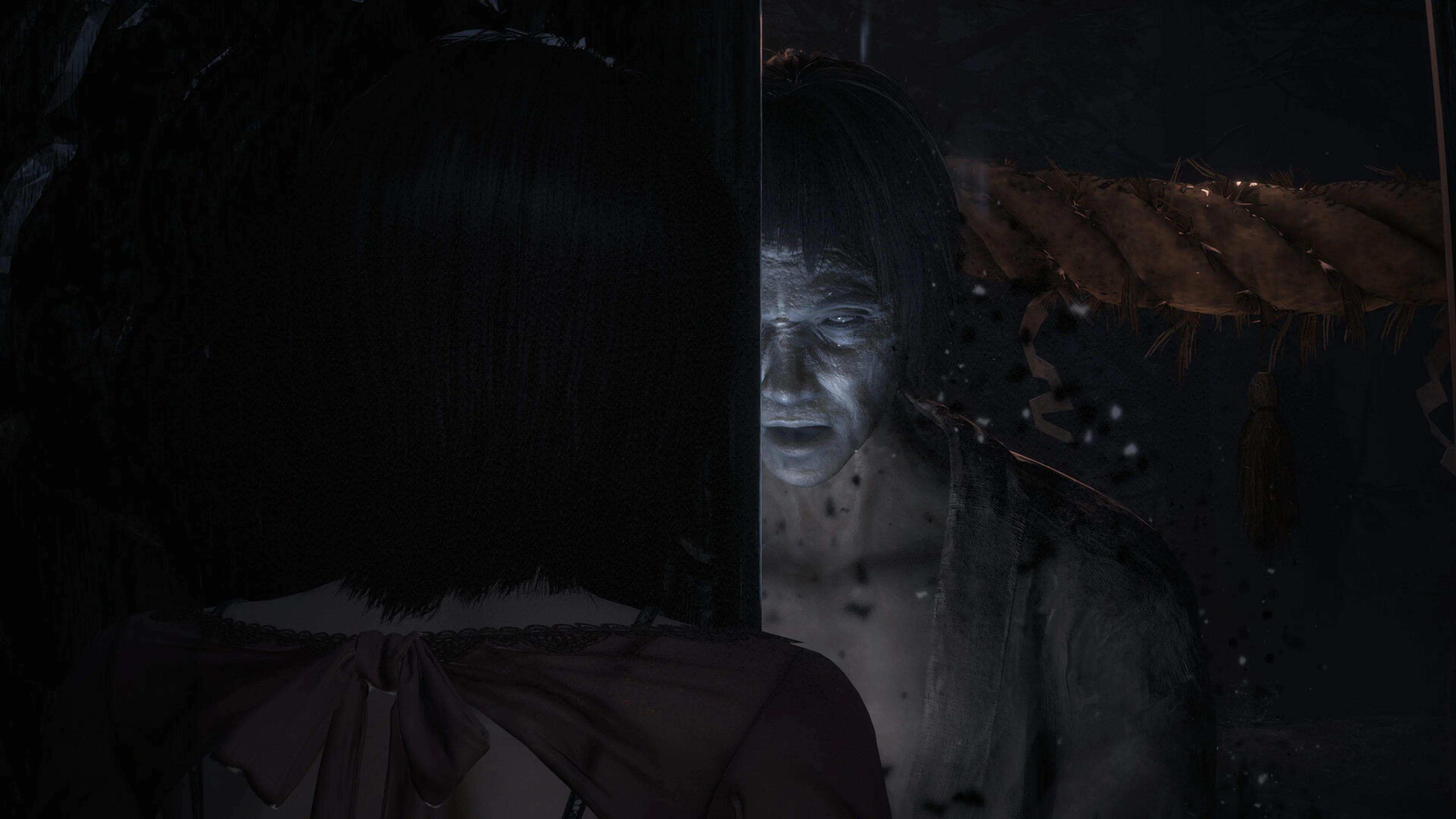 A pale ghost appears inches behind Mio in Fatal Frame II: Crimson Butterfly Remake.