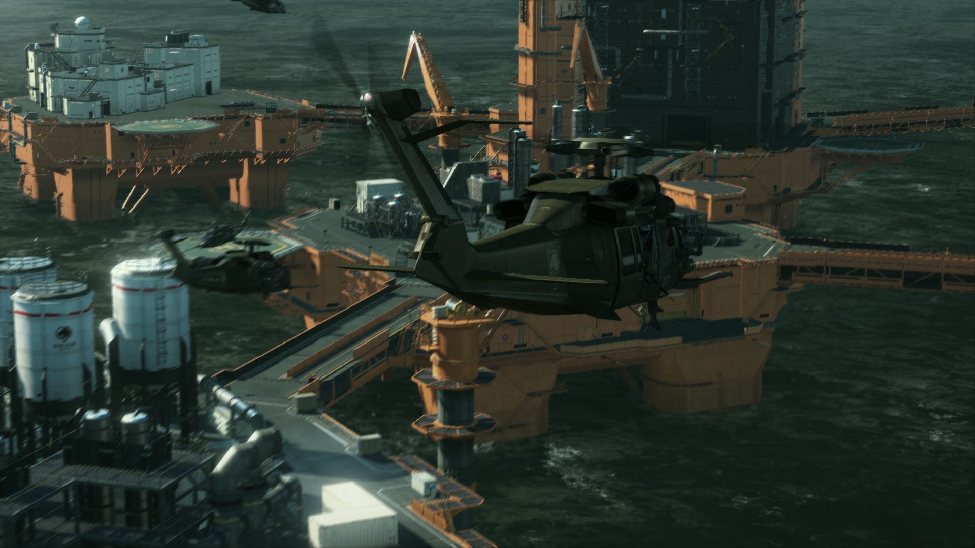 A helicopter hovers above offshore platforms and structures at Mother Base.