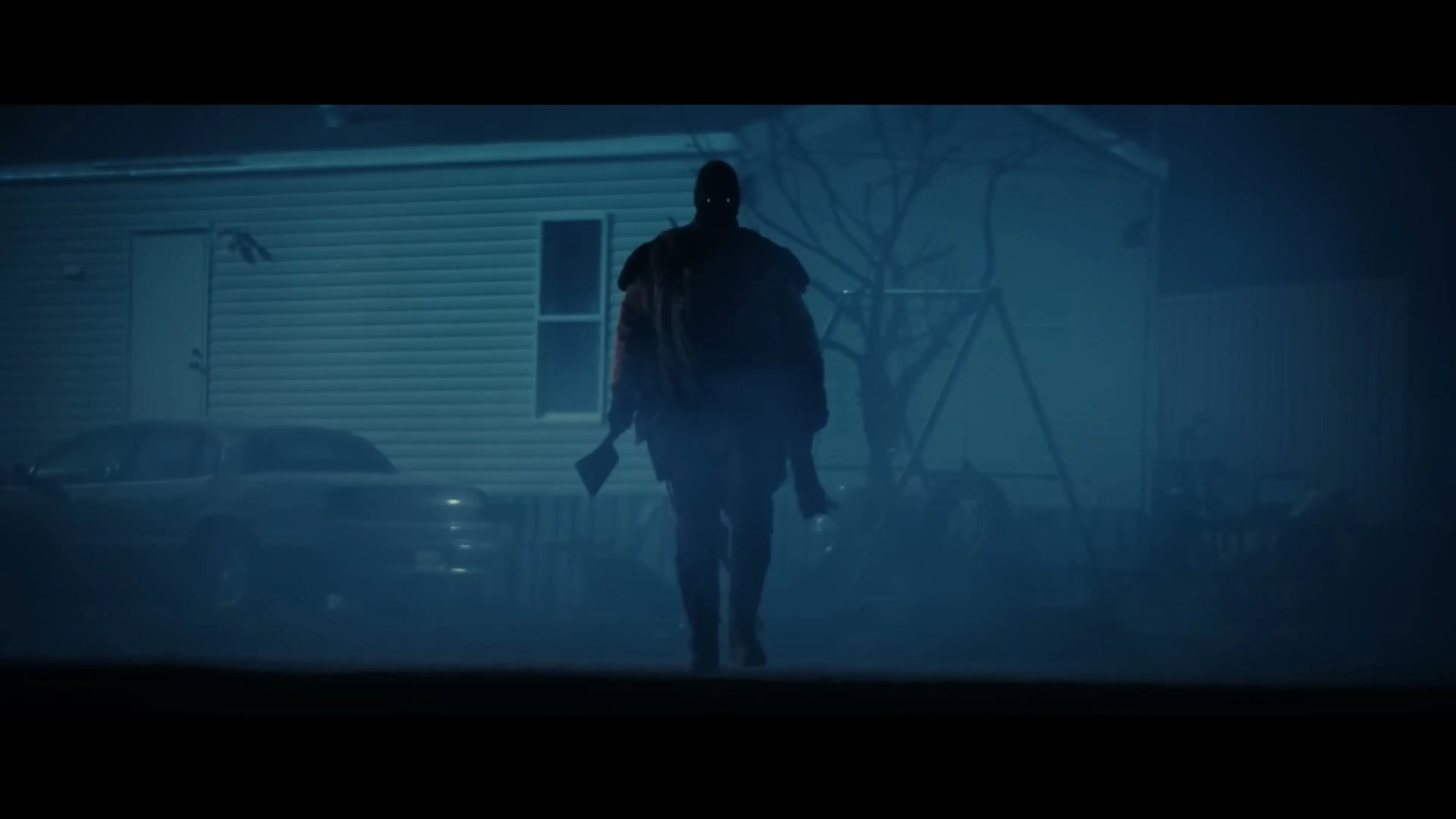 A masked super soldier approaches a home through blue fog in Onslaught.
