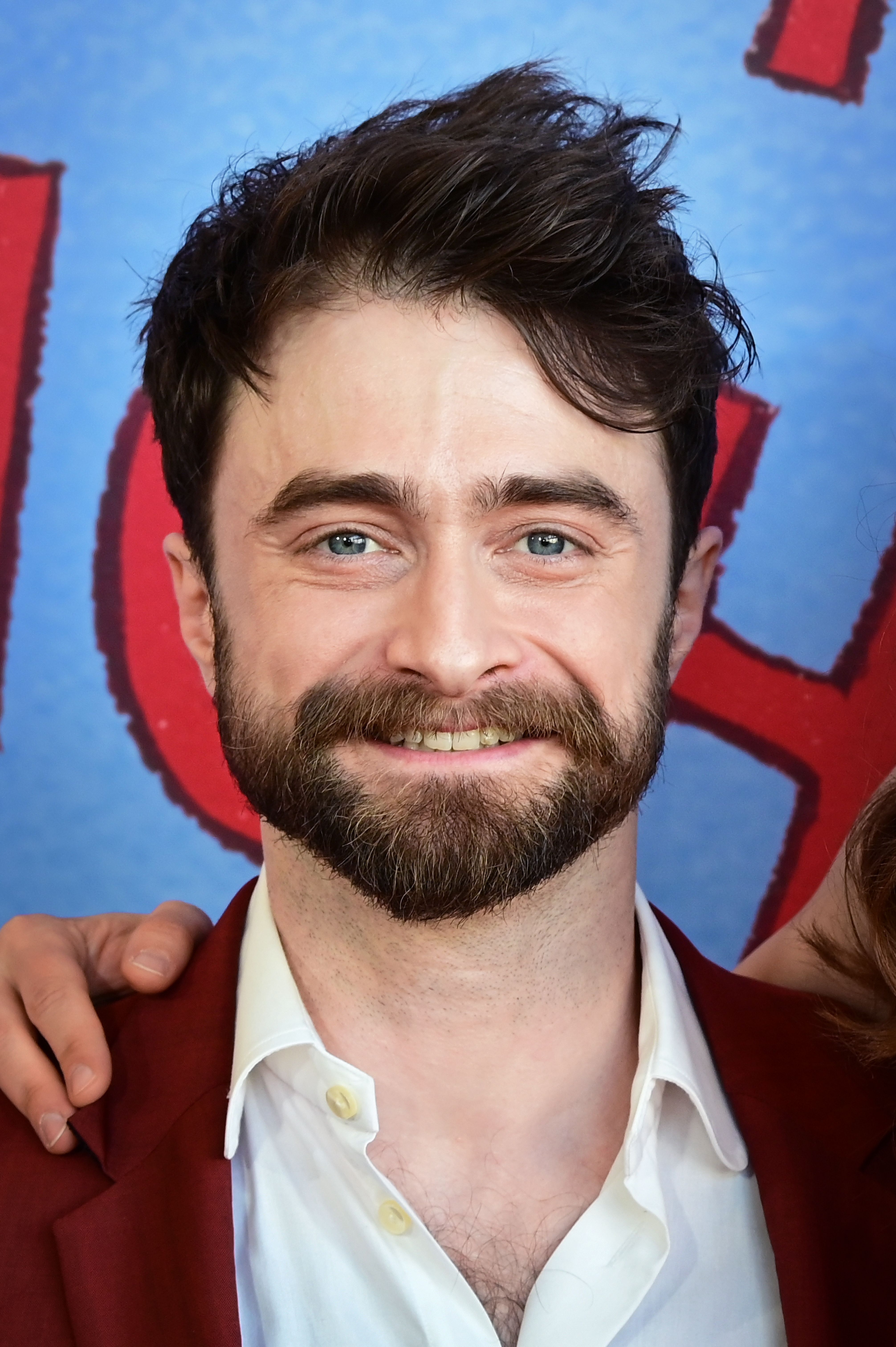 Daniel Radcliffe smiling with dark hair and a beard at the Lincoln Center Theater Gala in May 2026.