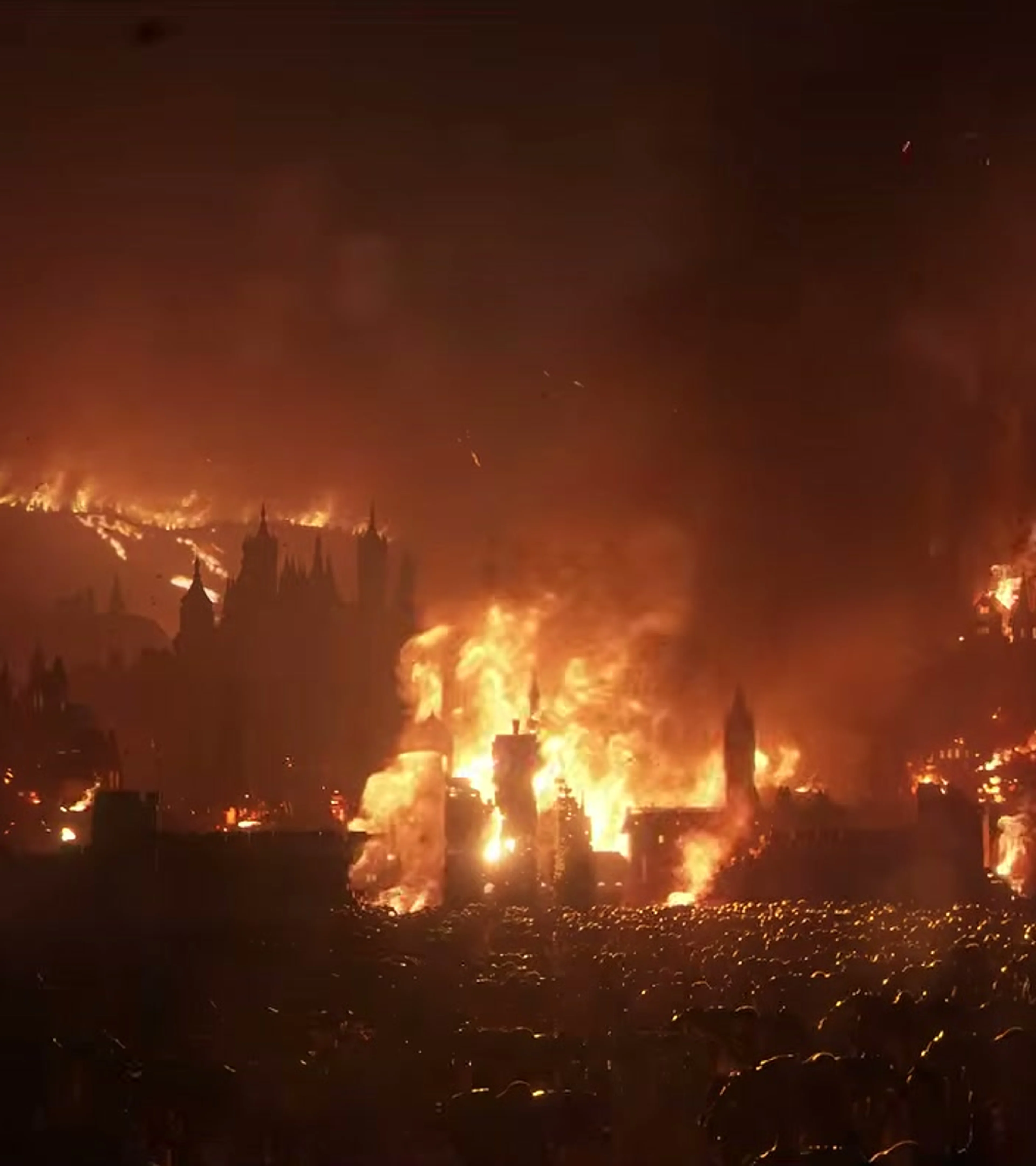 A vast gothic city burns beneath a dark red sky.
