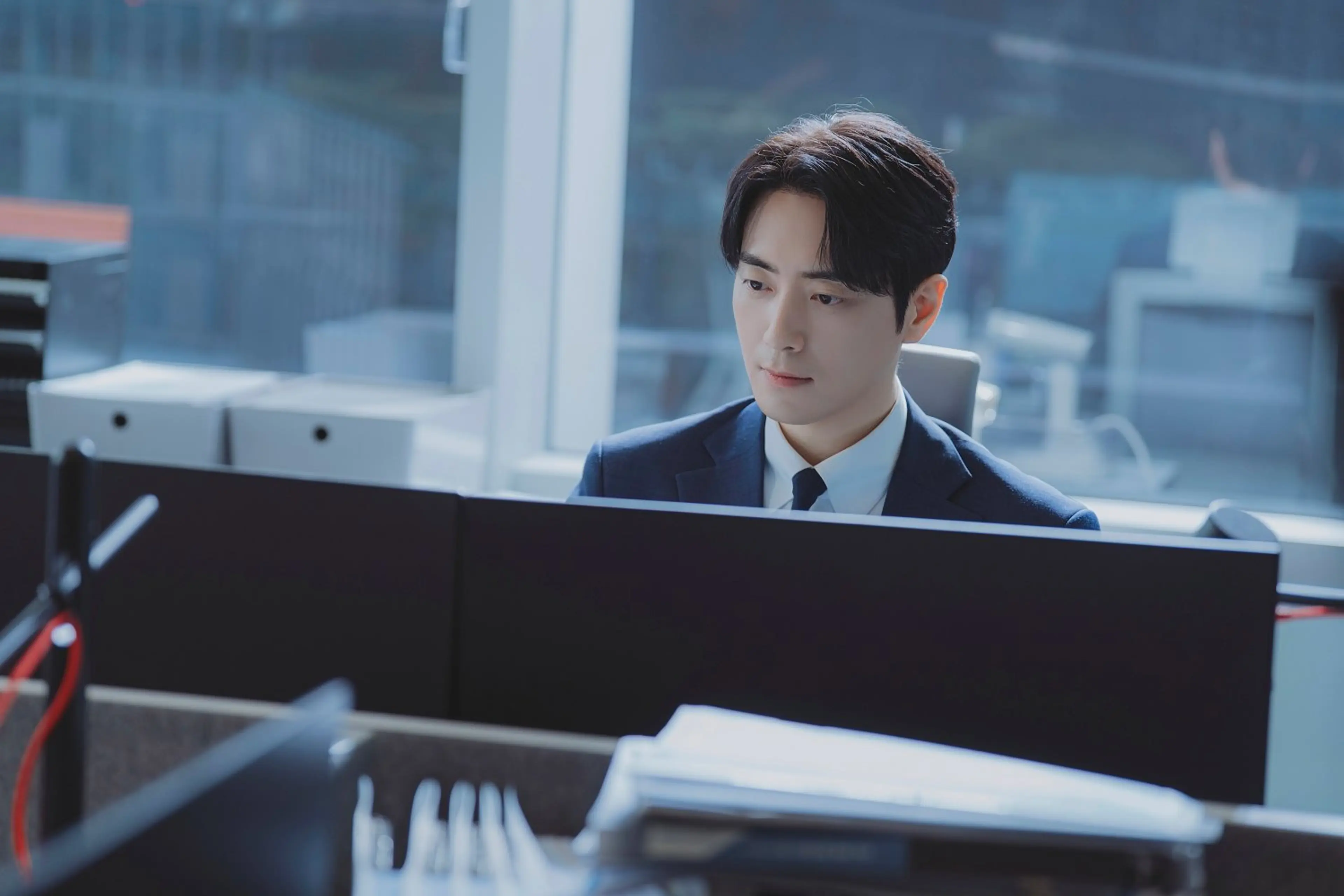 Gong Eun-tae works at his desk.