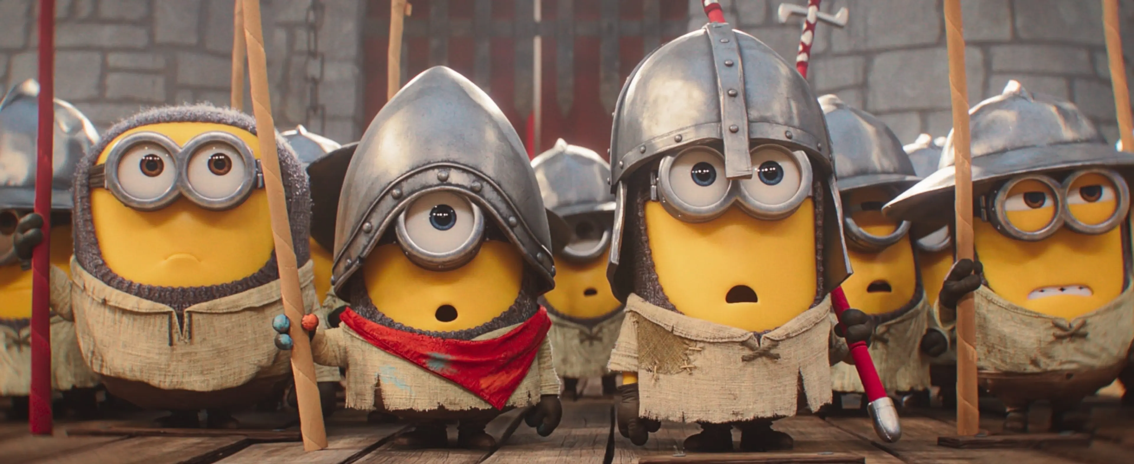 Minions in medieval costumes charge forward in Minions & Monsters.