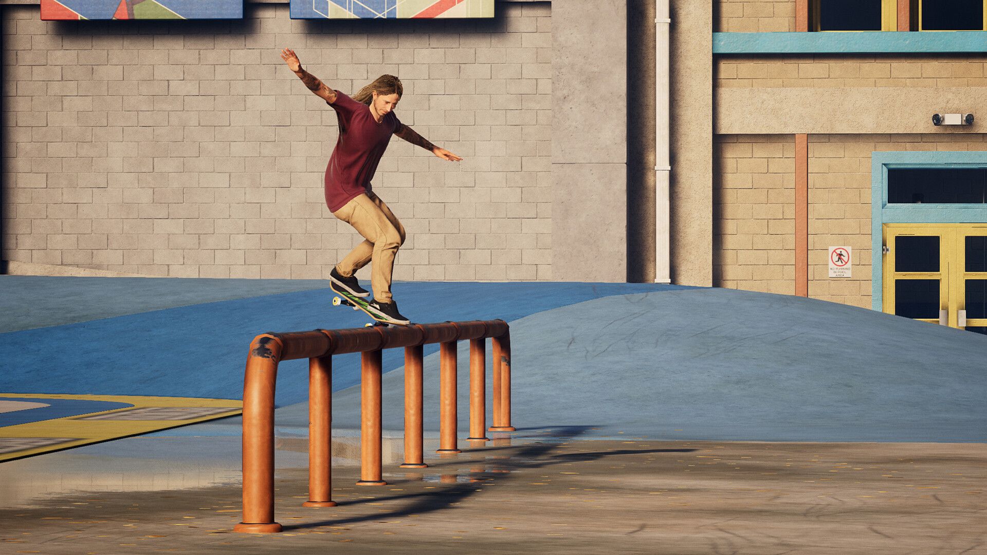 A skater balances along an orange rail in a schoolyard, showing the obstacles used for grind tricks.