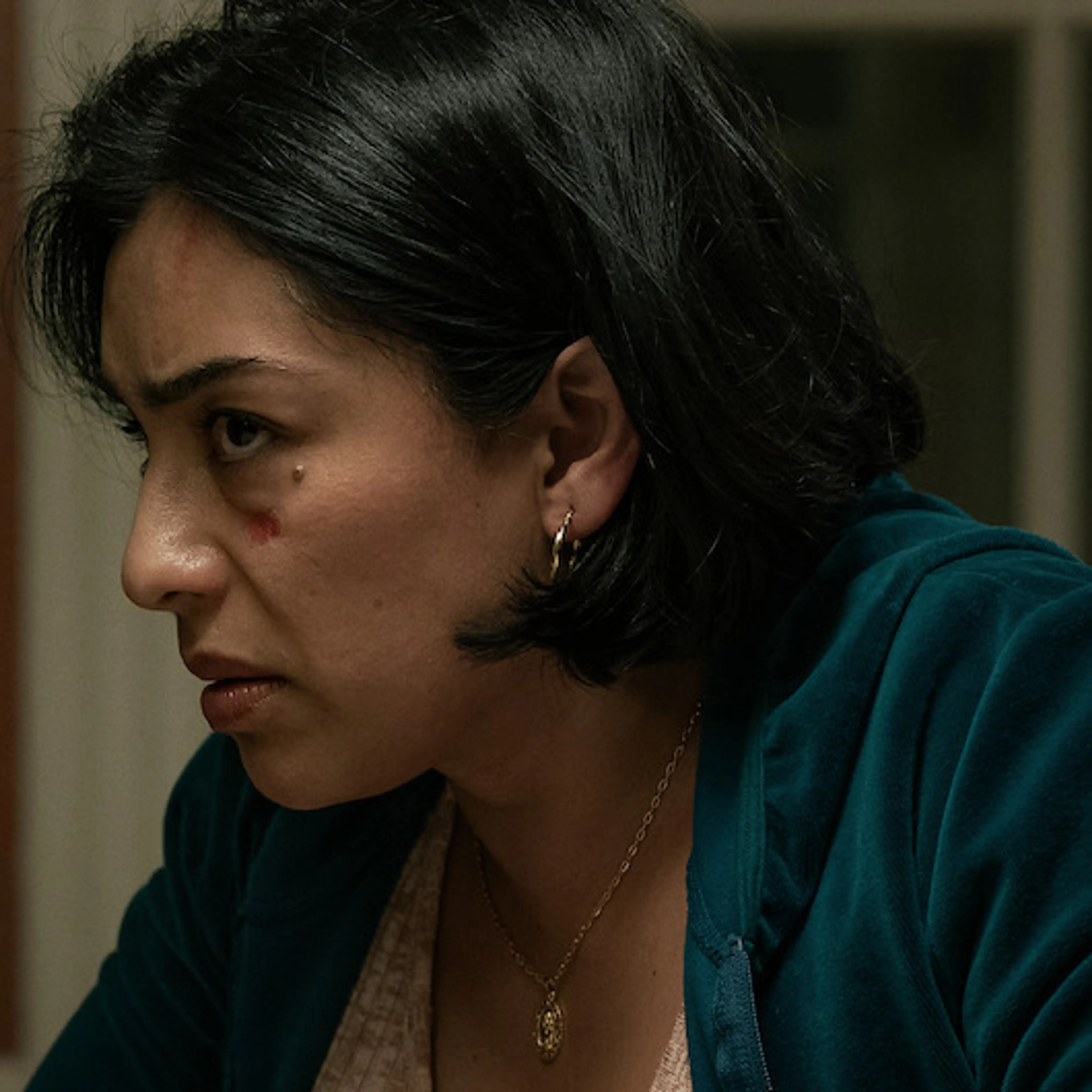 Adriana Paz in an official Animals production photograph, seated at a table.