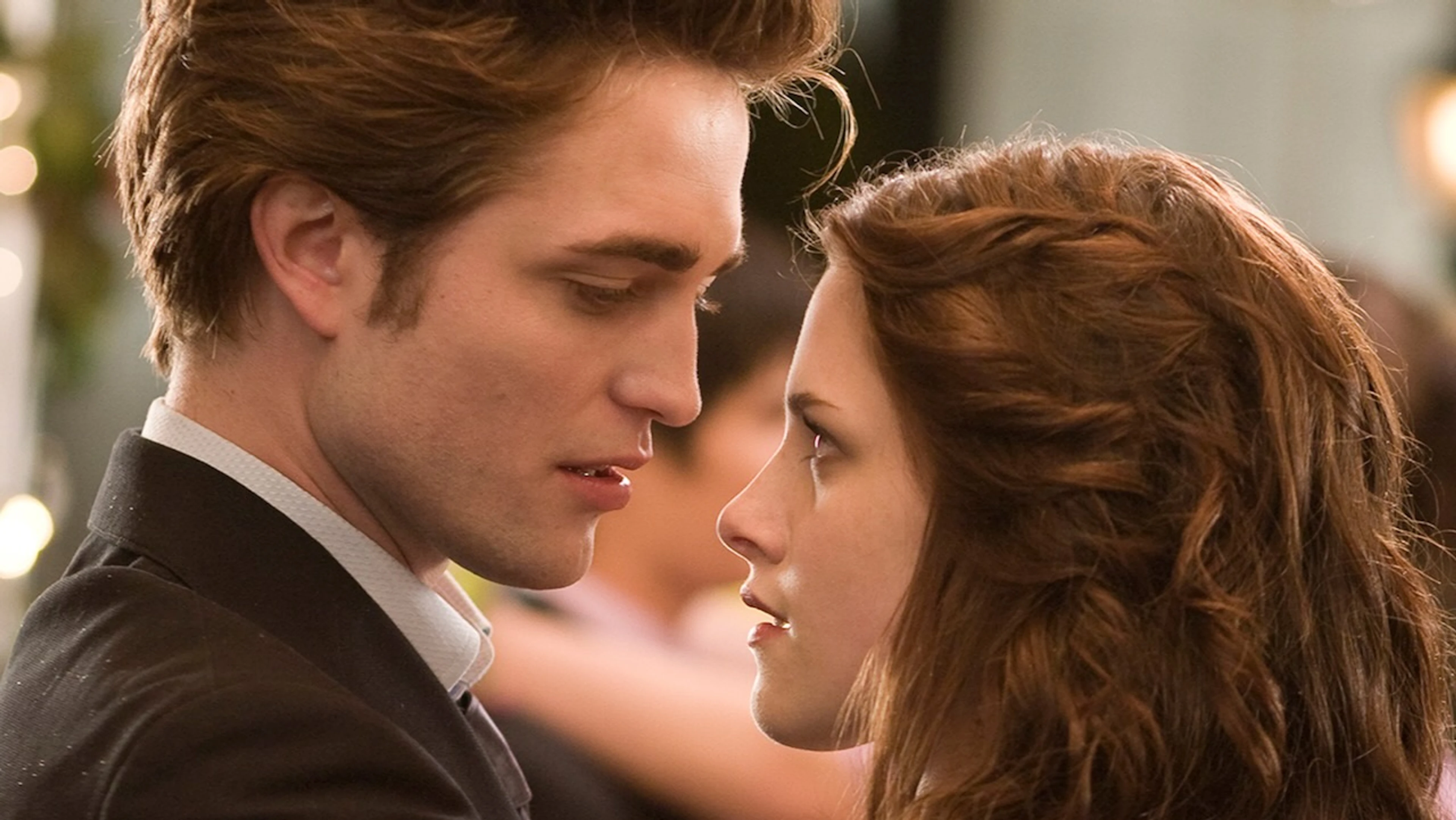 Edward Cullen and Bella Swan face each other in a Twilight film scene.