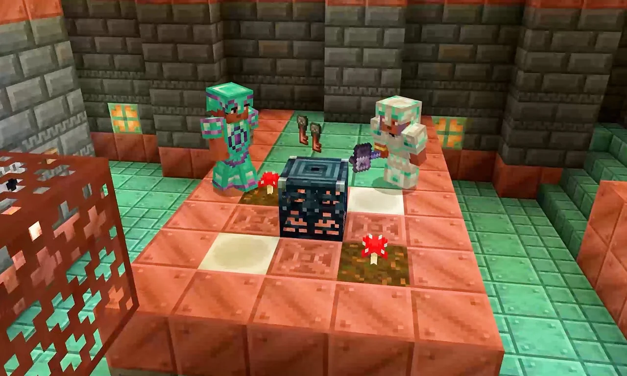 Two Minecraft players standing beside a trial spawner with trial keys on the floor.