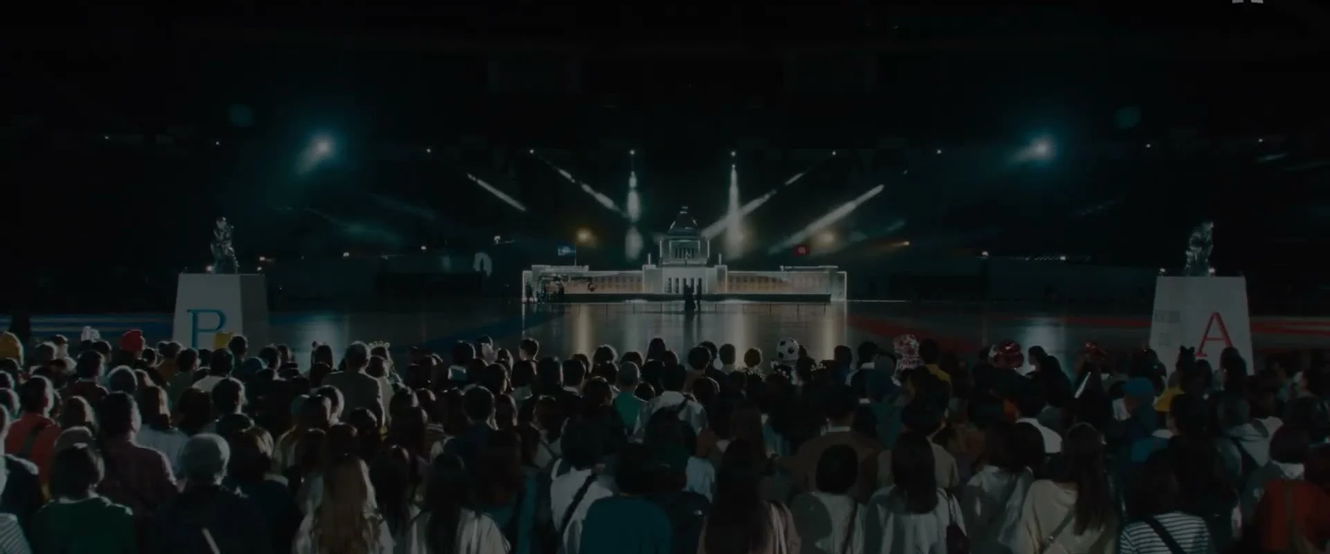 A crowd faces the brightly lit Quiztopia television stage.