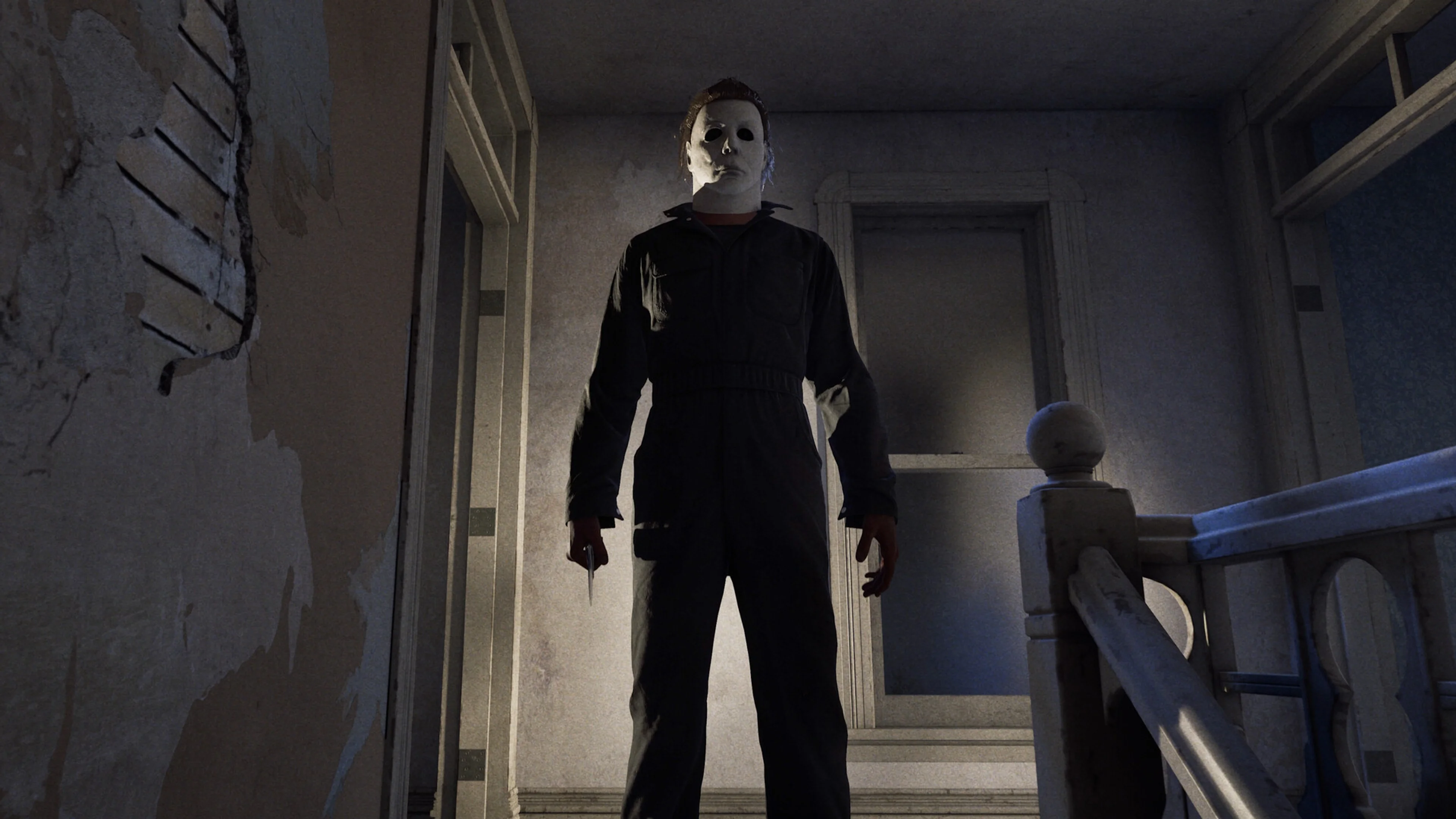 Michael Myers stands with a knife at the top of a damaged staircase in Halloween: The Game.