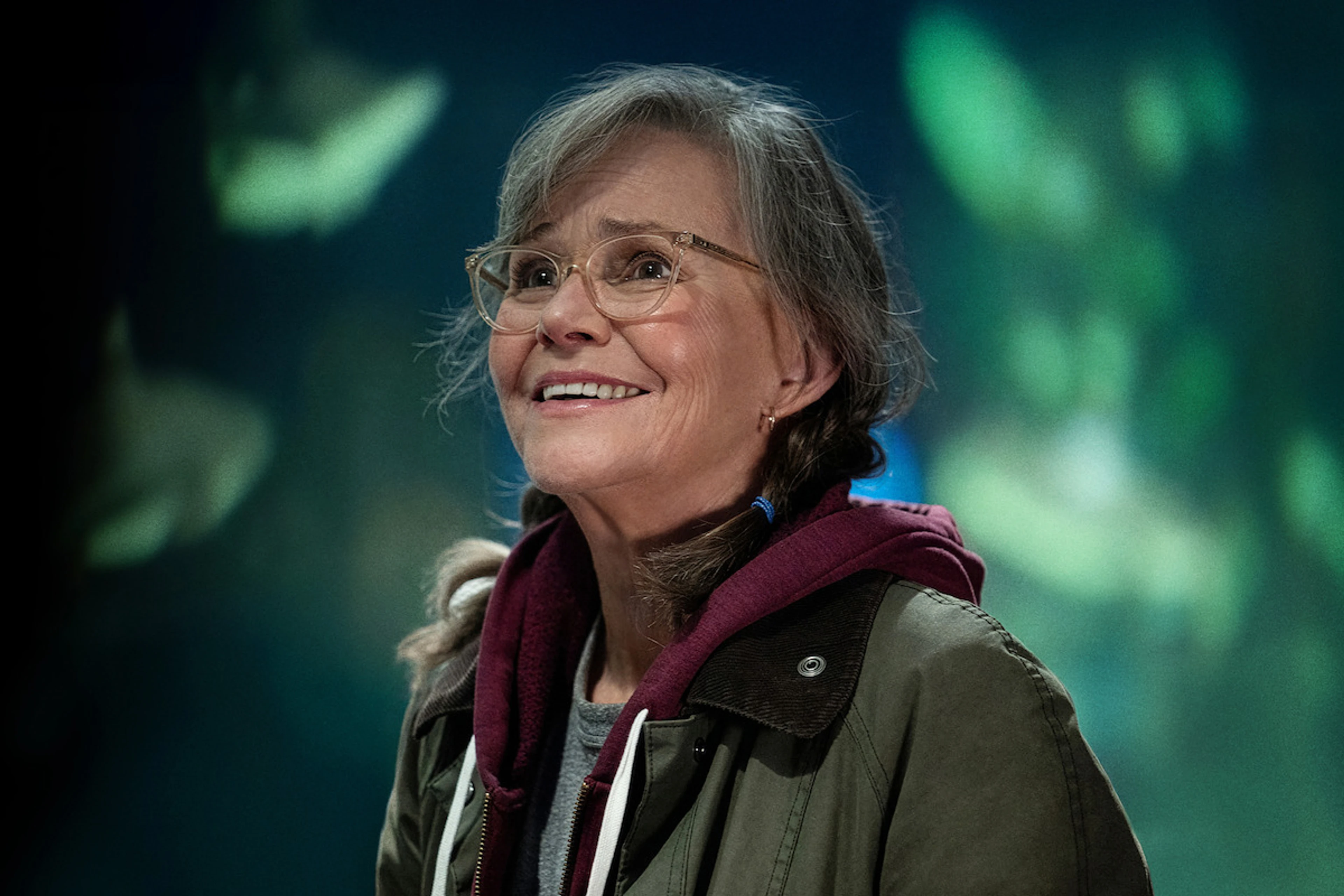 Sally Field as Tova Sullivan smiles inside the aquarium in Remarkably Bright Creatures.