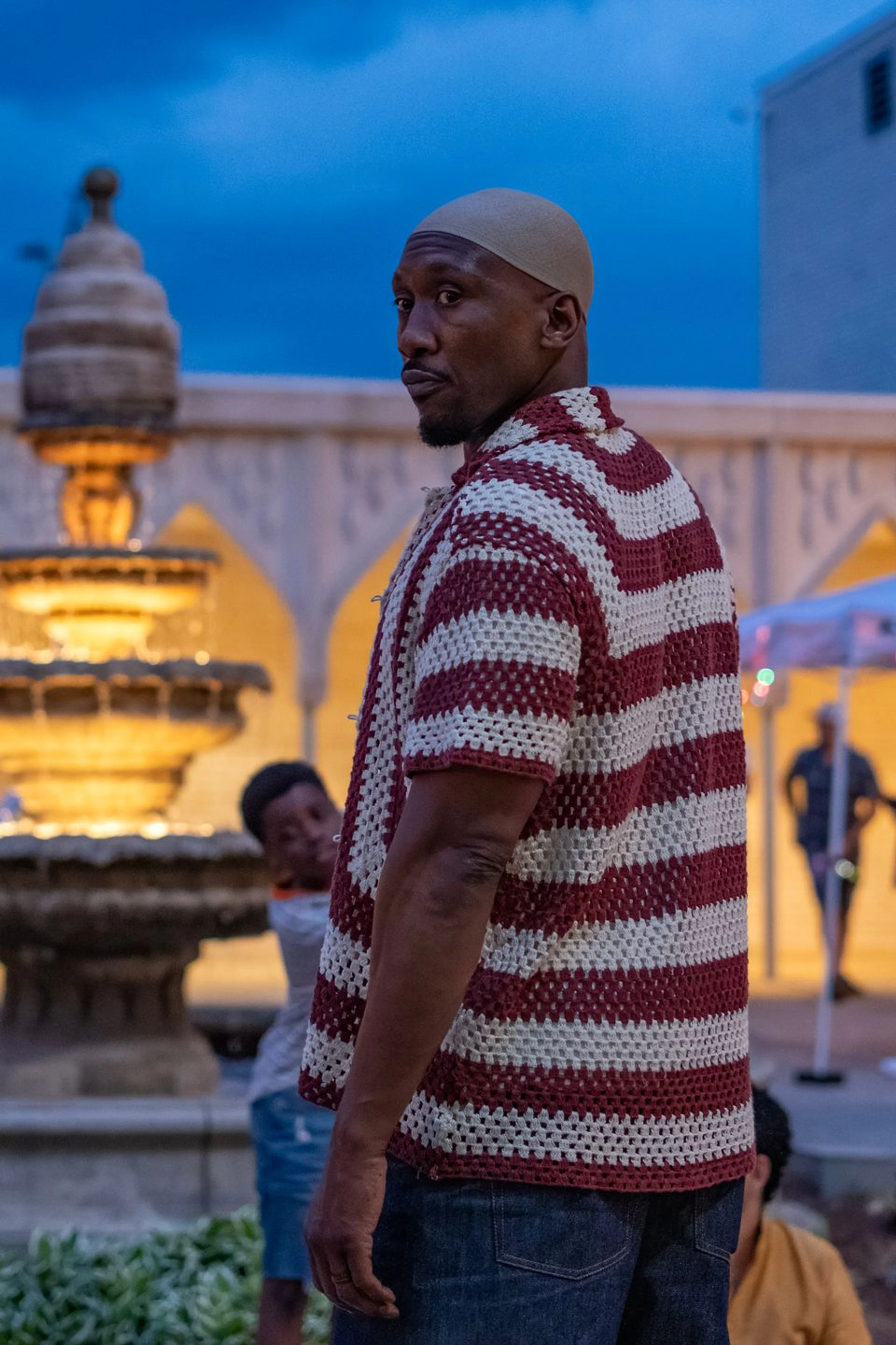 Mahershala Ali as Latif stands outdoors in Your Mother Your Mother Your Mother.
