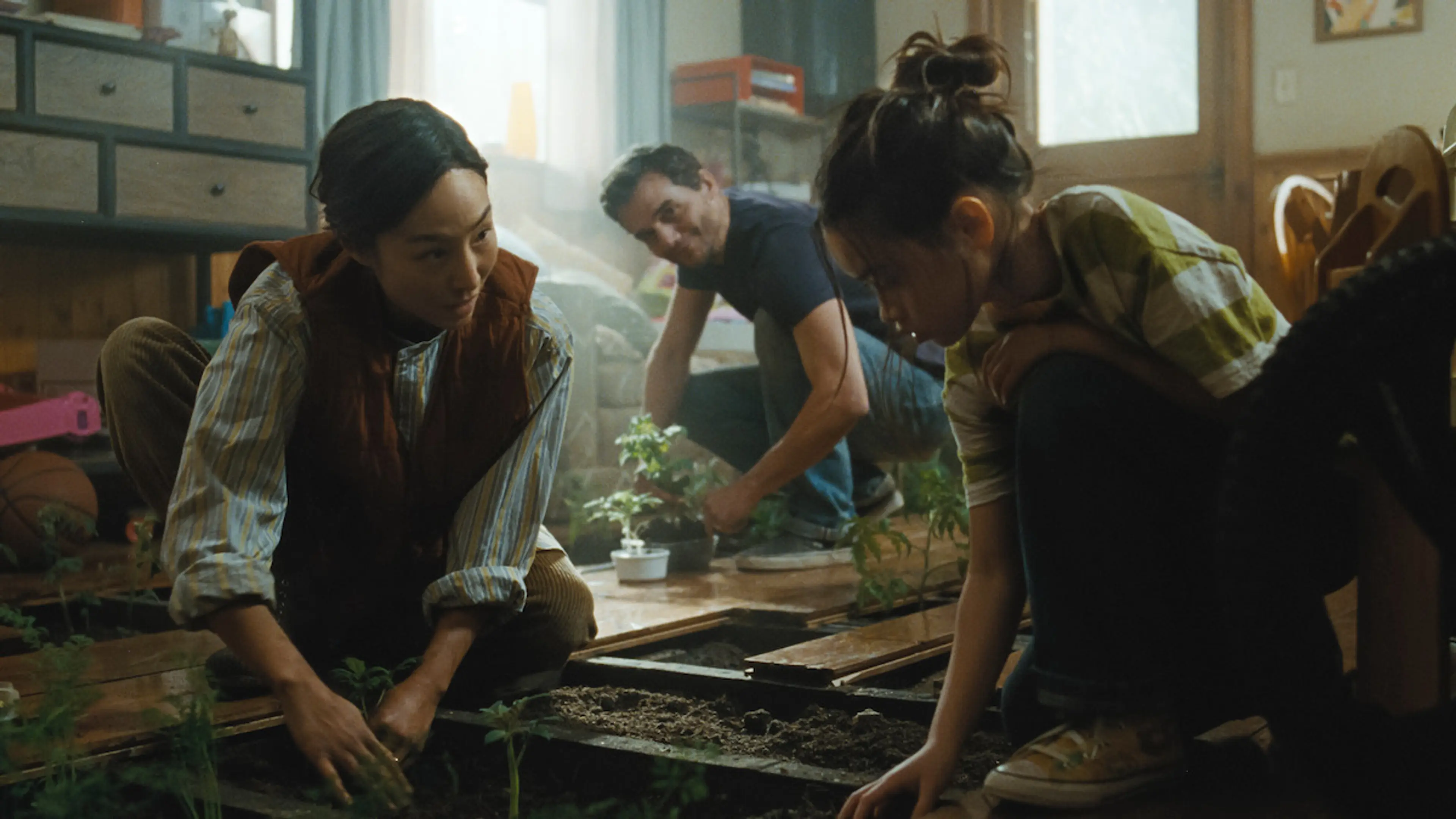 Ann, Jason, and Ruth tend plants inside the Delgado home in The Last House.
