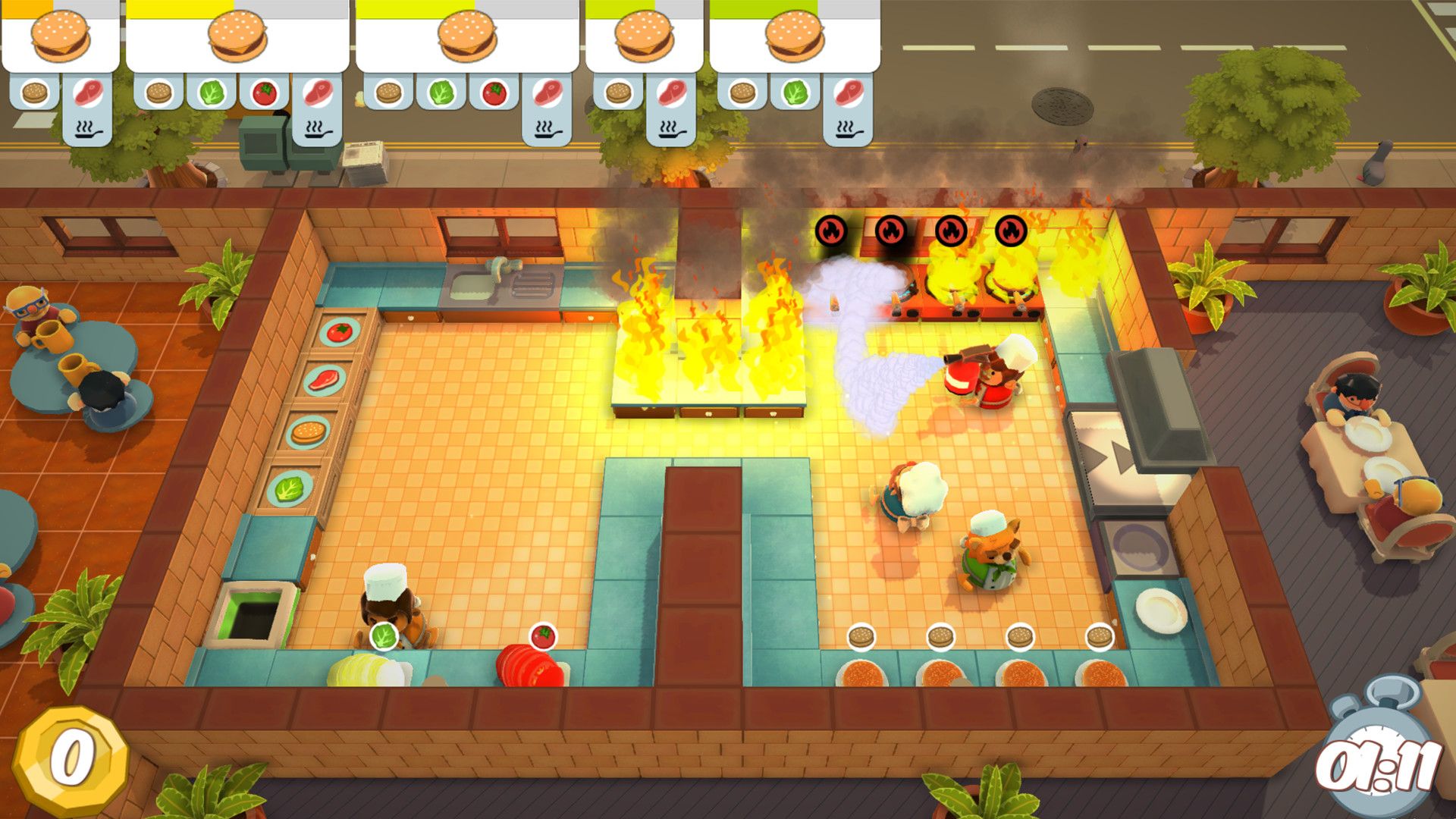 Orders line the top of a kitchen screen while flames spread by a cooking station.