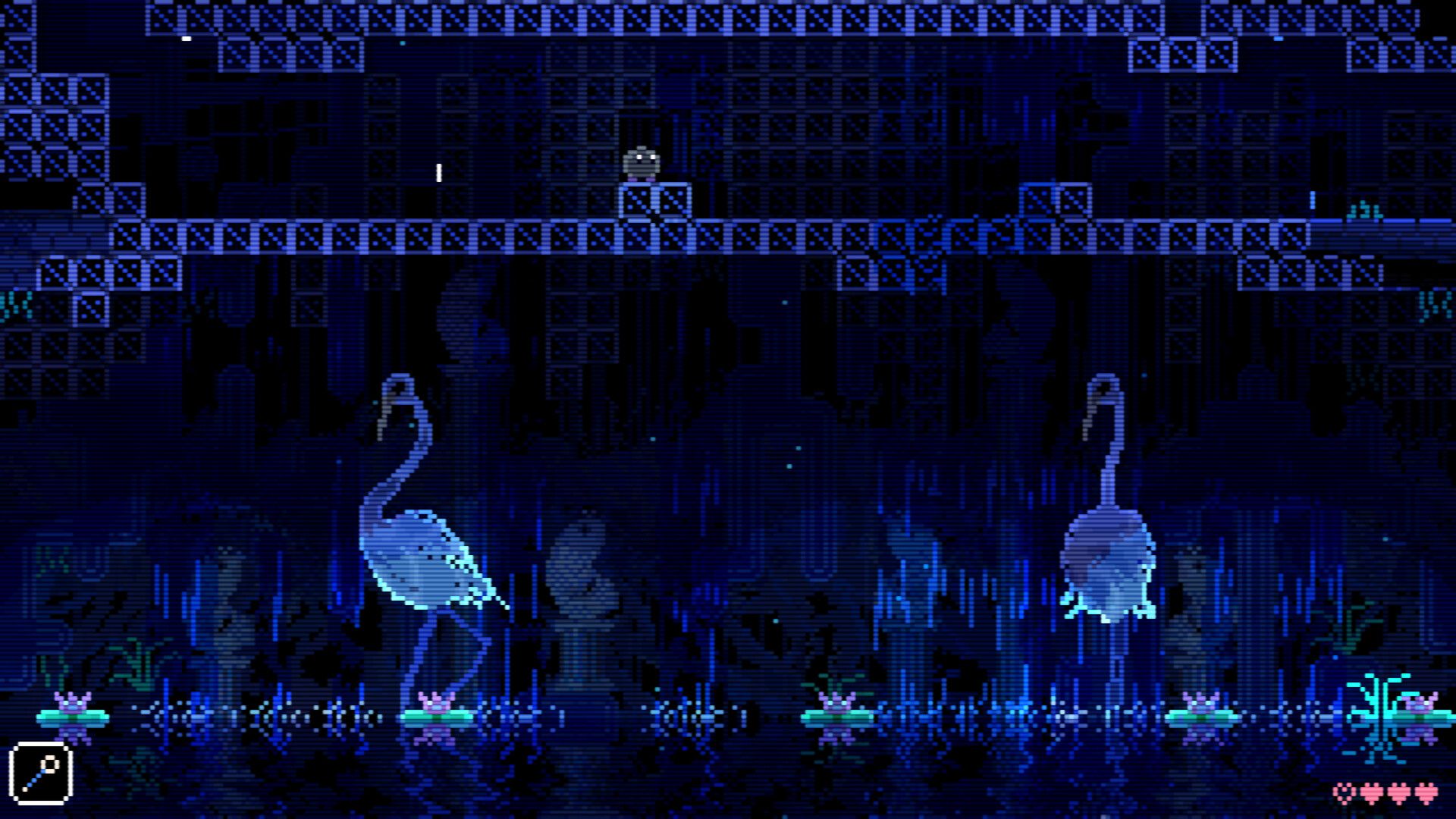 The player stands on an upper platform above two long-legged birds in a blue underground room.