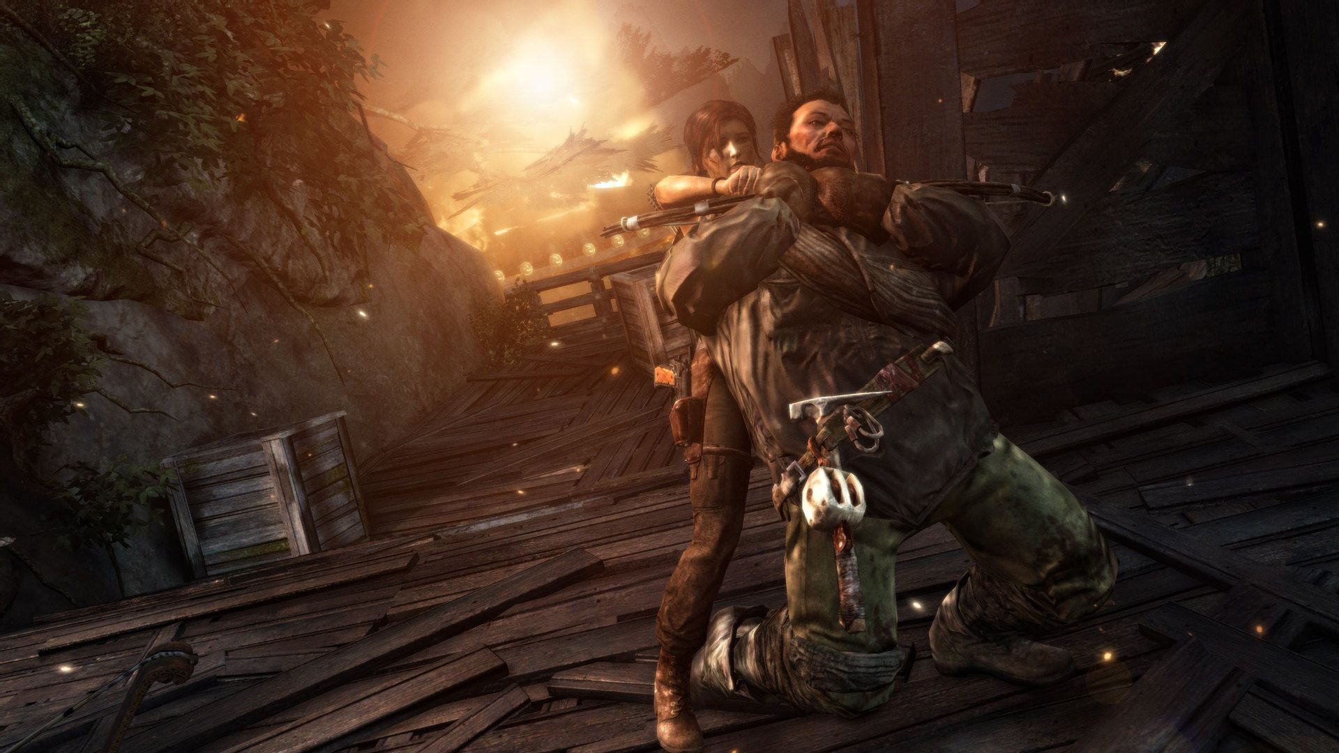 Lara pulls a man away from danger inside a dark wooden structure.