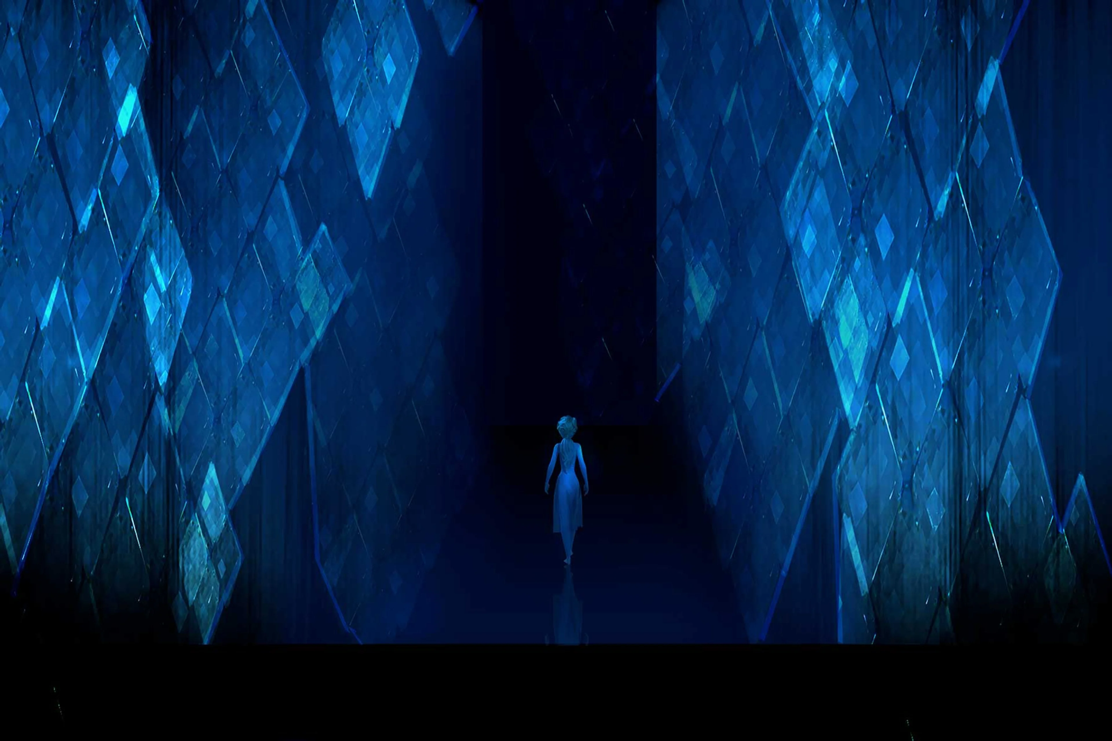 Elsa stands inside the glowing ice corridors of Ahtohallan in Frozen 2.