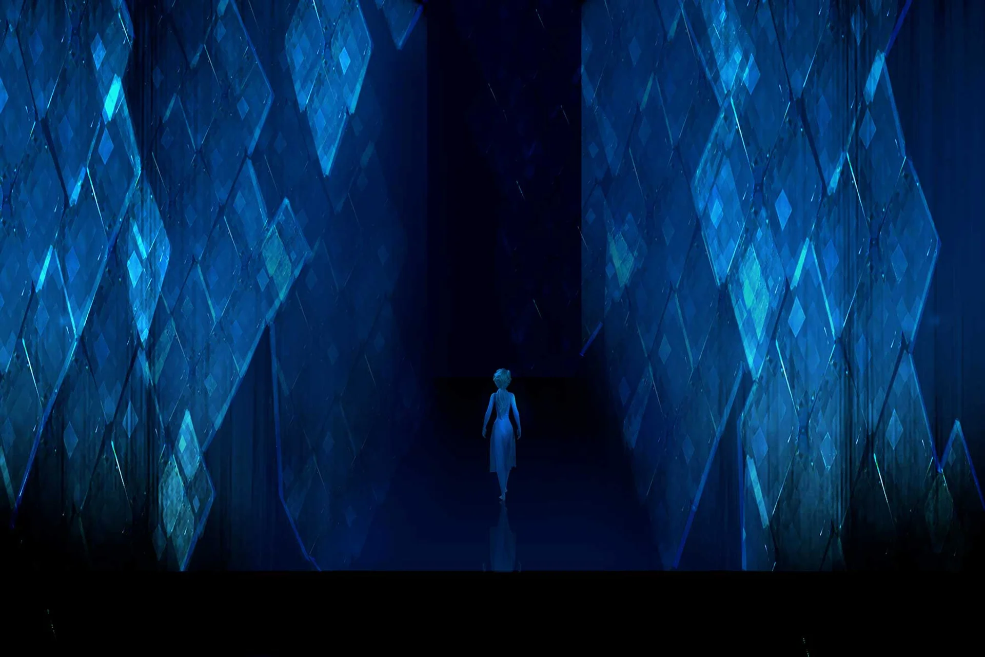Elsa stands inside the glowing ice corridors of Ahtohallan in Frozen 2.