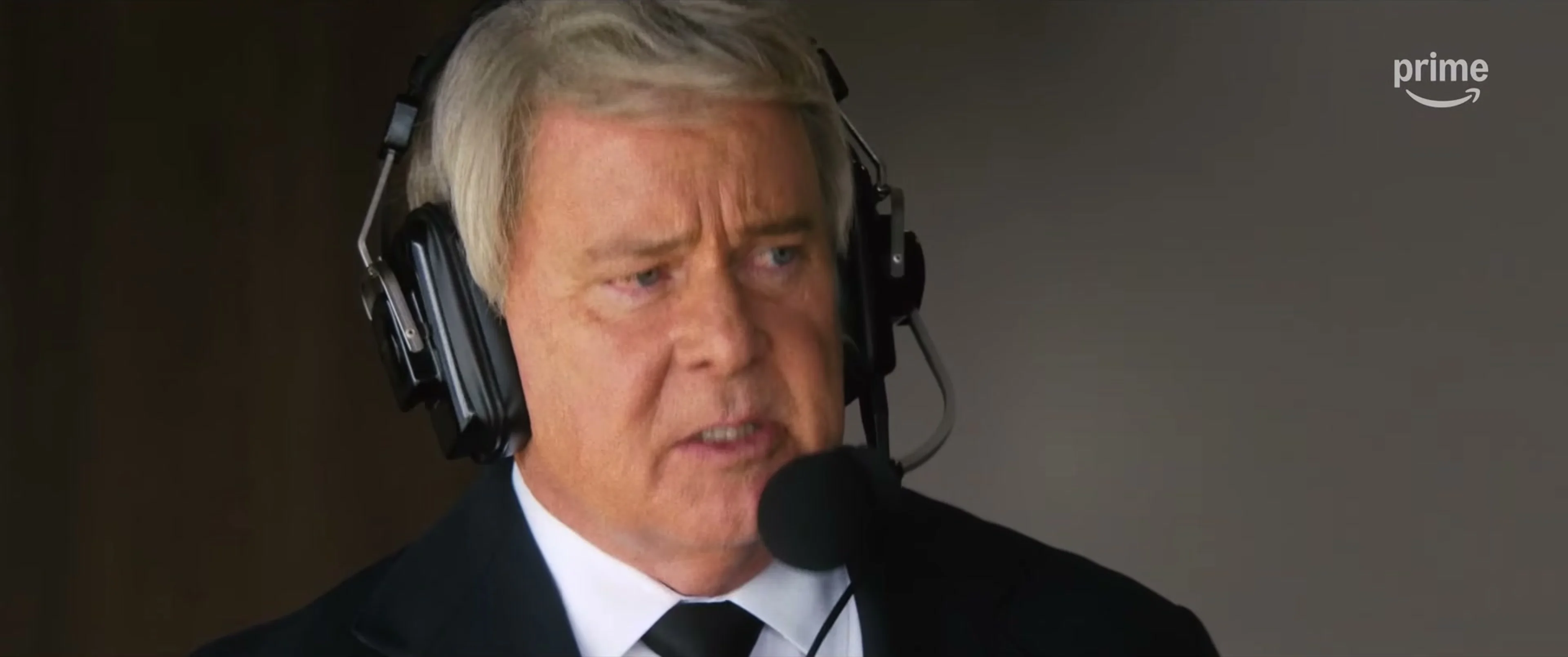 Nicolas Cage as John Madden wears a headset in a commentary booth.