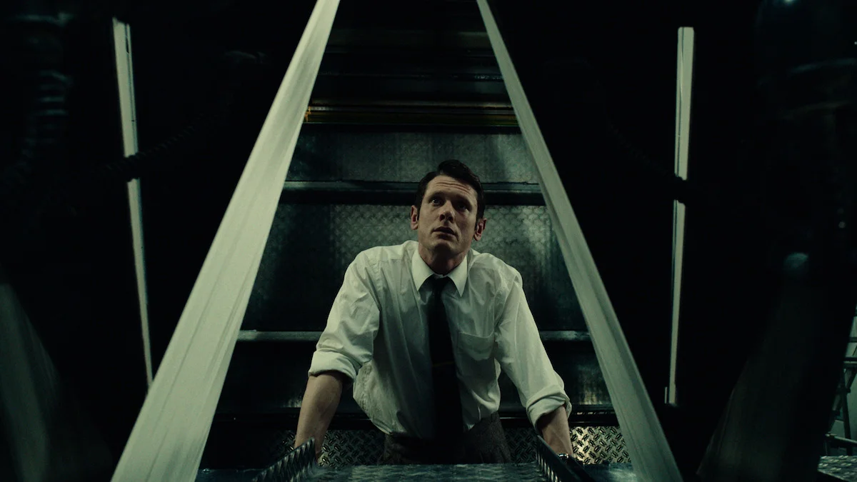 Jack O’Connell as Larry Lamb looks up from a printing press inside The Sun newsroom in Ink.