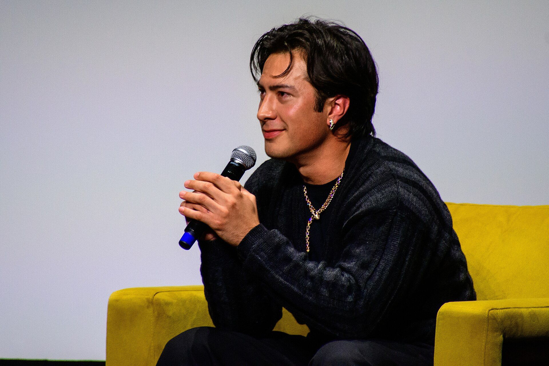 Hudson Williams speaking into a microphone at TIFF in 2026.