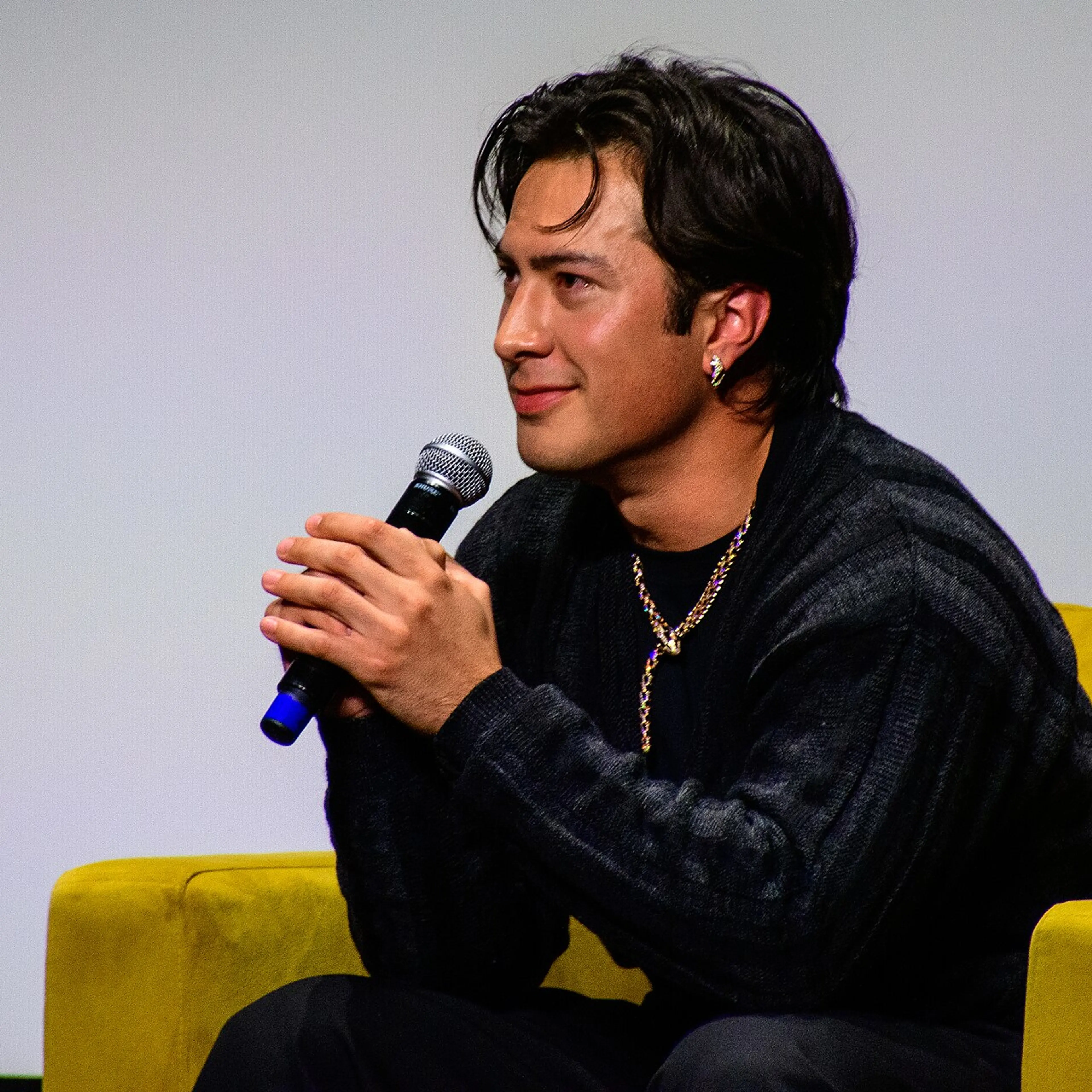 Hudson Williams speaking into a microphone at TIFF in 2026.