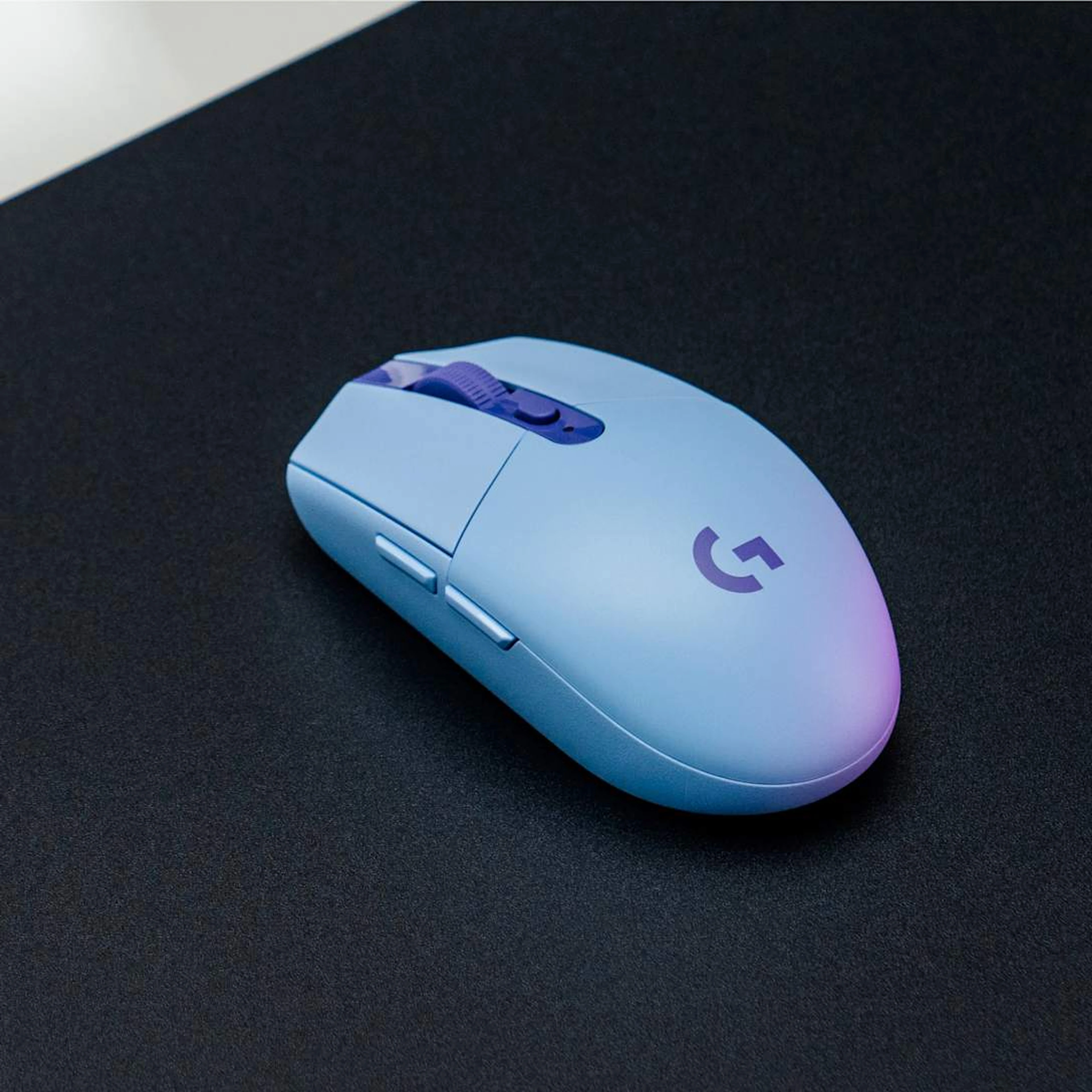 Lilac Logitech G305 on a dark mouse mat