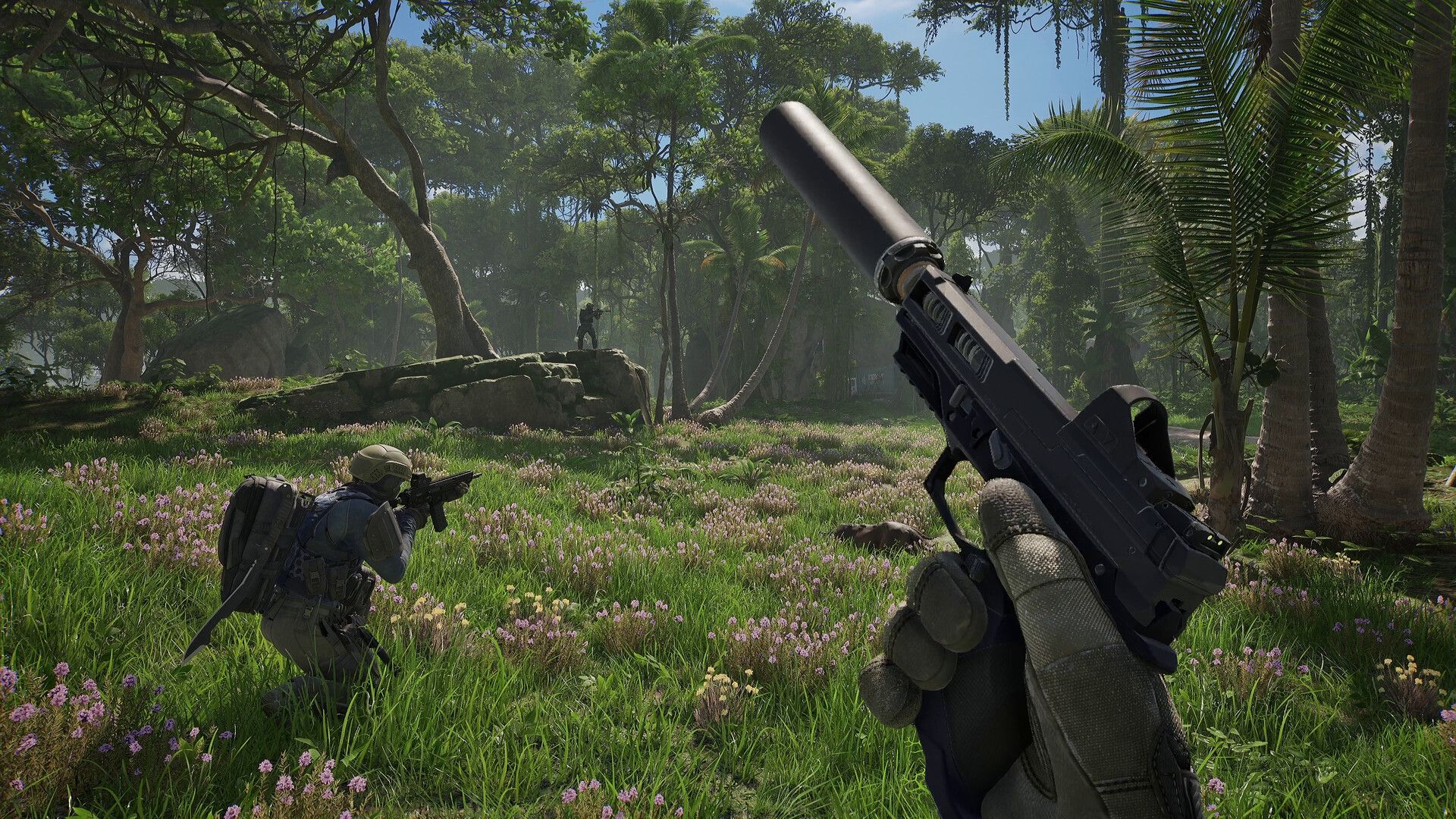 A first-person weapon and armed squad members in a flower-covered clearing in PUBG: Black Budget.