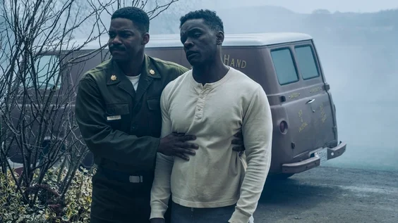 Jovan Adepo and Chris Chalk stand beside a van in IT: Welcome to Derry.