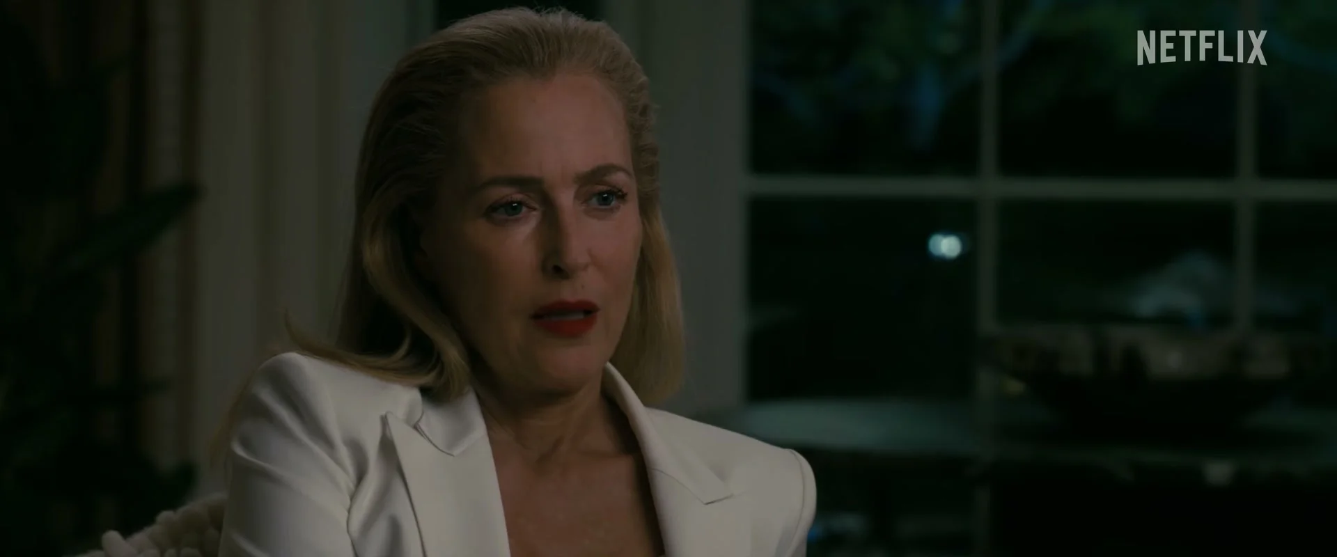 Gillian Anderson as fixer Dayle speaks inside the Kimball home in Animals.