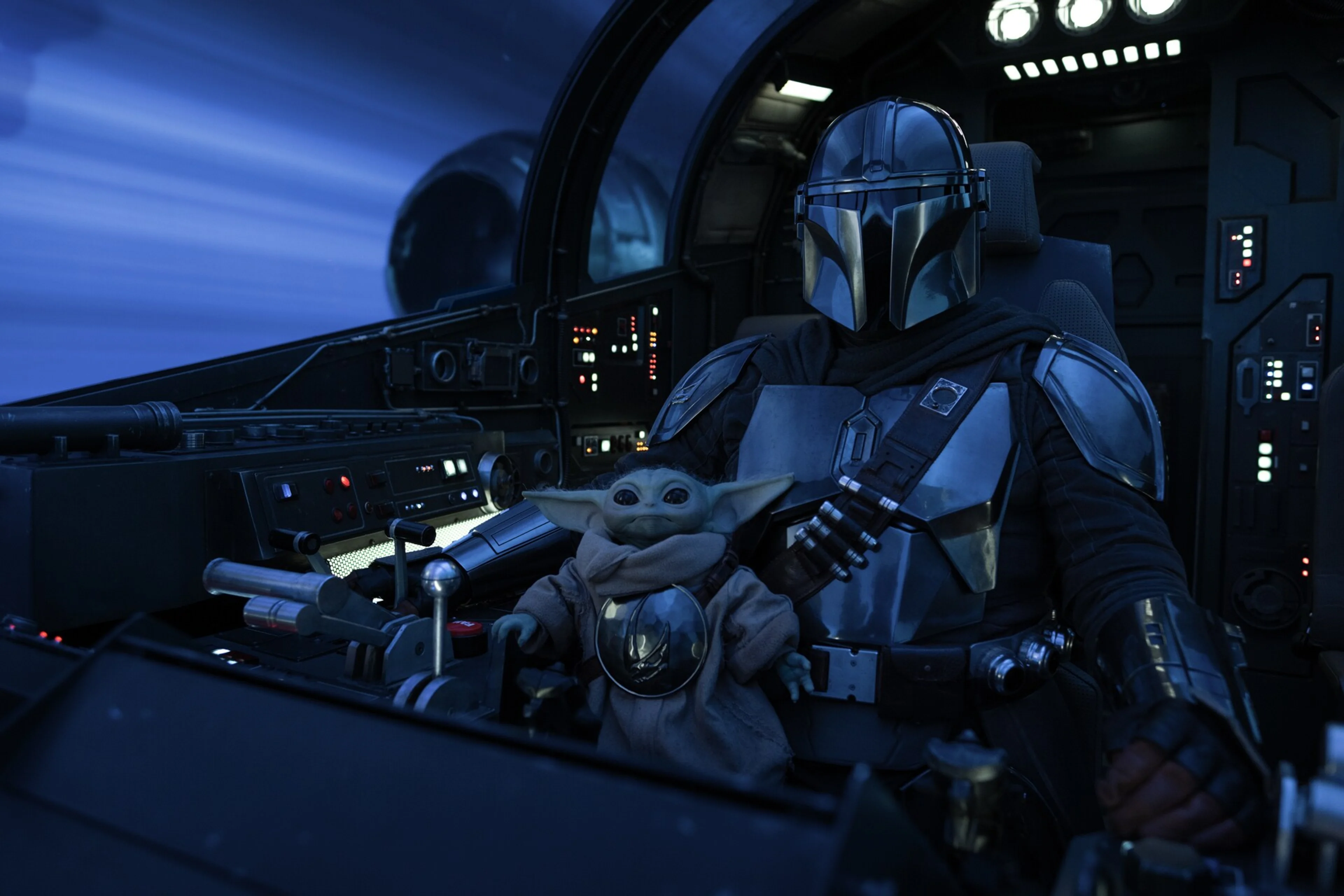 Din Djarin and Grogu sit together in the cockpit of the Razor Crest in official film imagery.