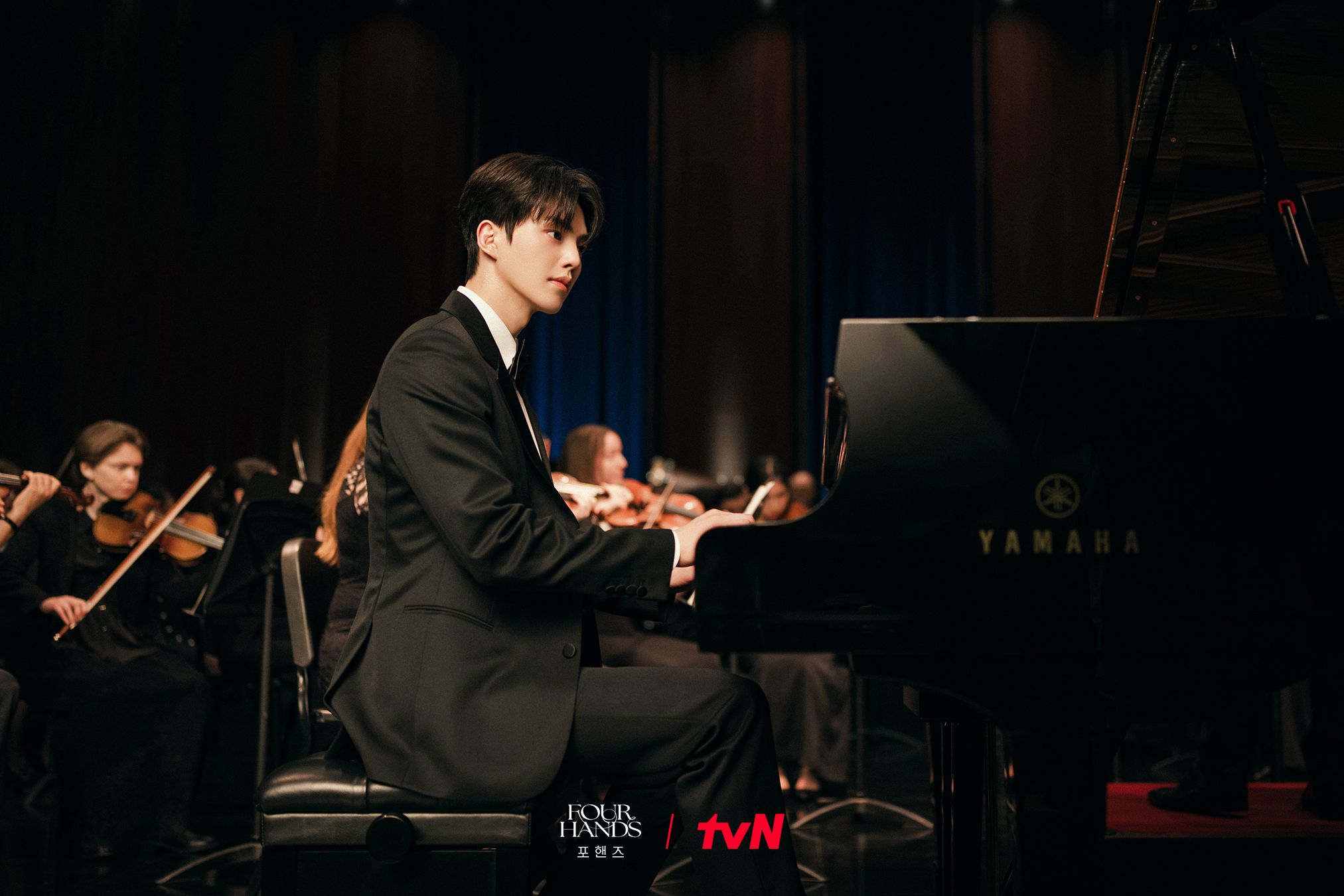 A young pianist performs beside an orchestra in Four Hands, Two Sonatas.