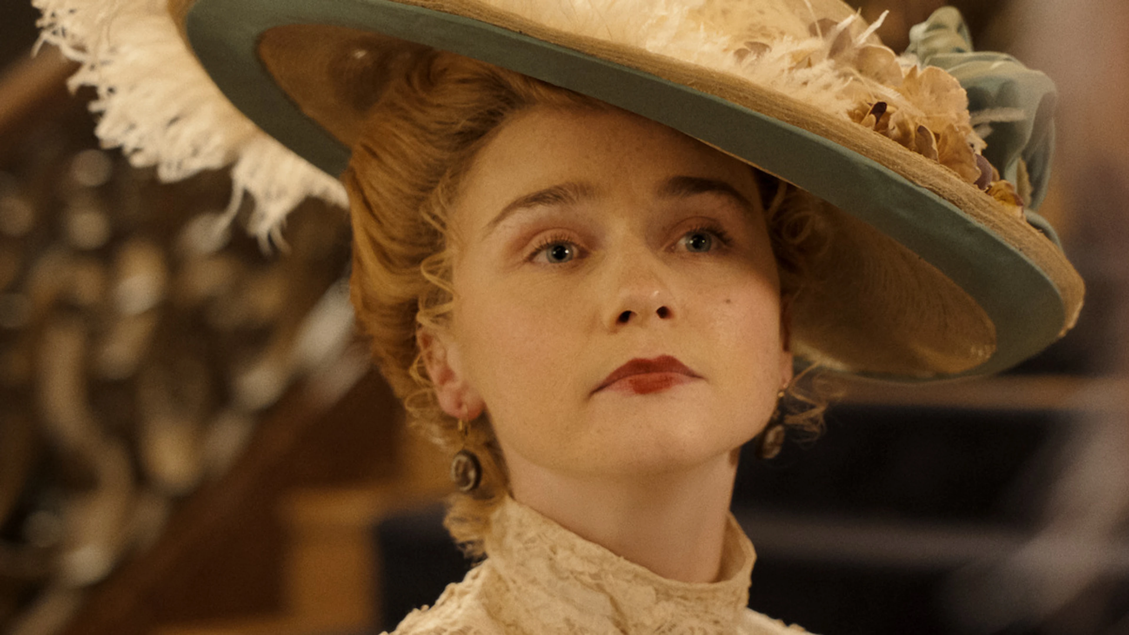 Jessica Barden wears a wide cream hat as Nance O’Neil in Monster: The Lizzie Borden Story.