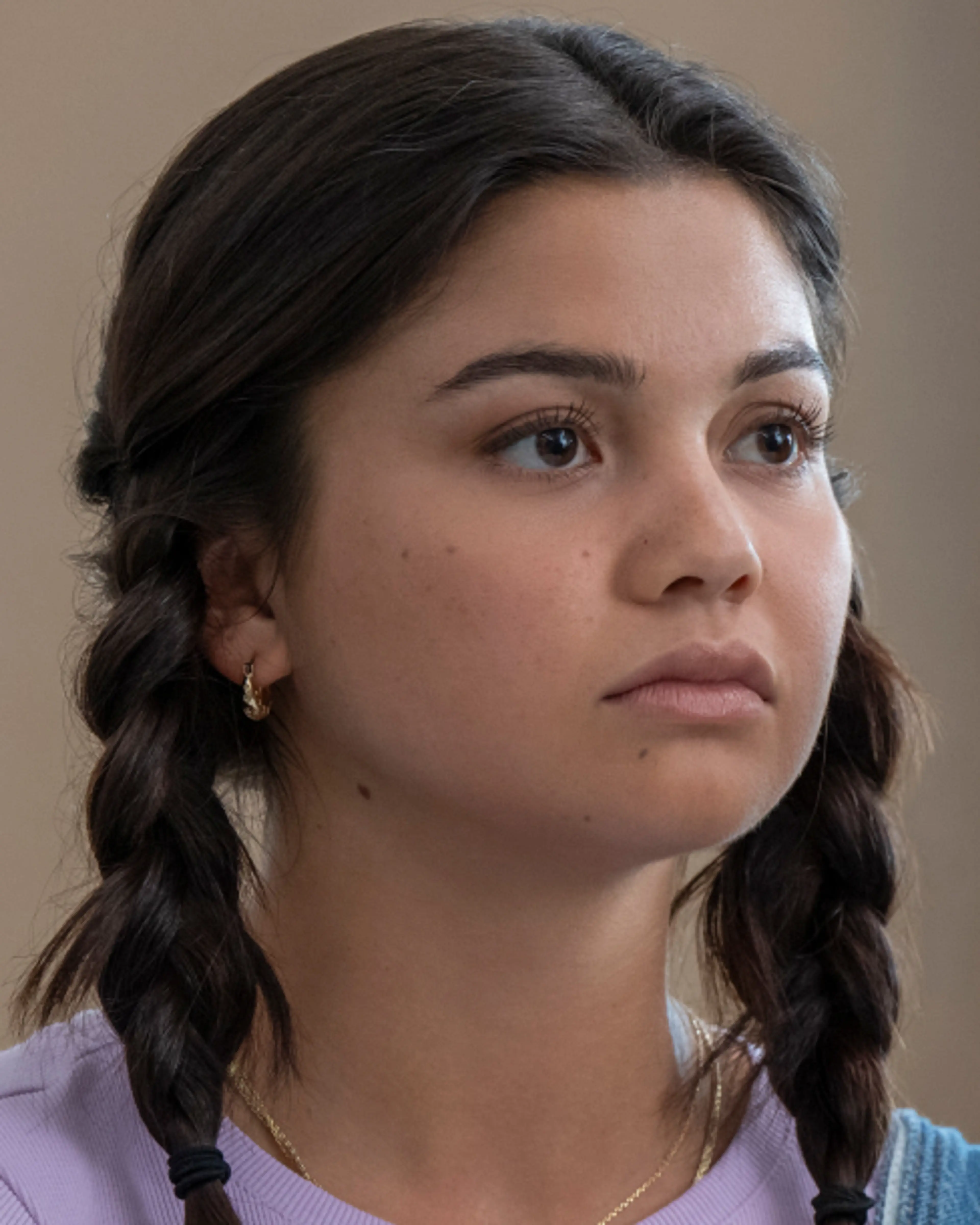 Siena Agudong as Sue Snell and Joel Oulette as Tommy Ross sit beside each other in a classroom.