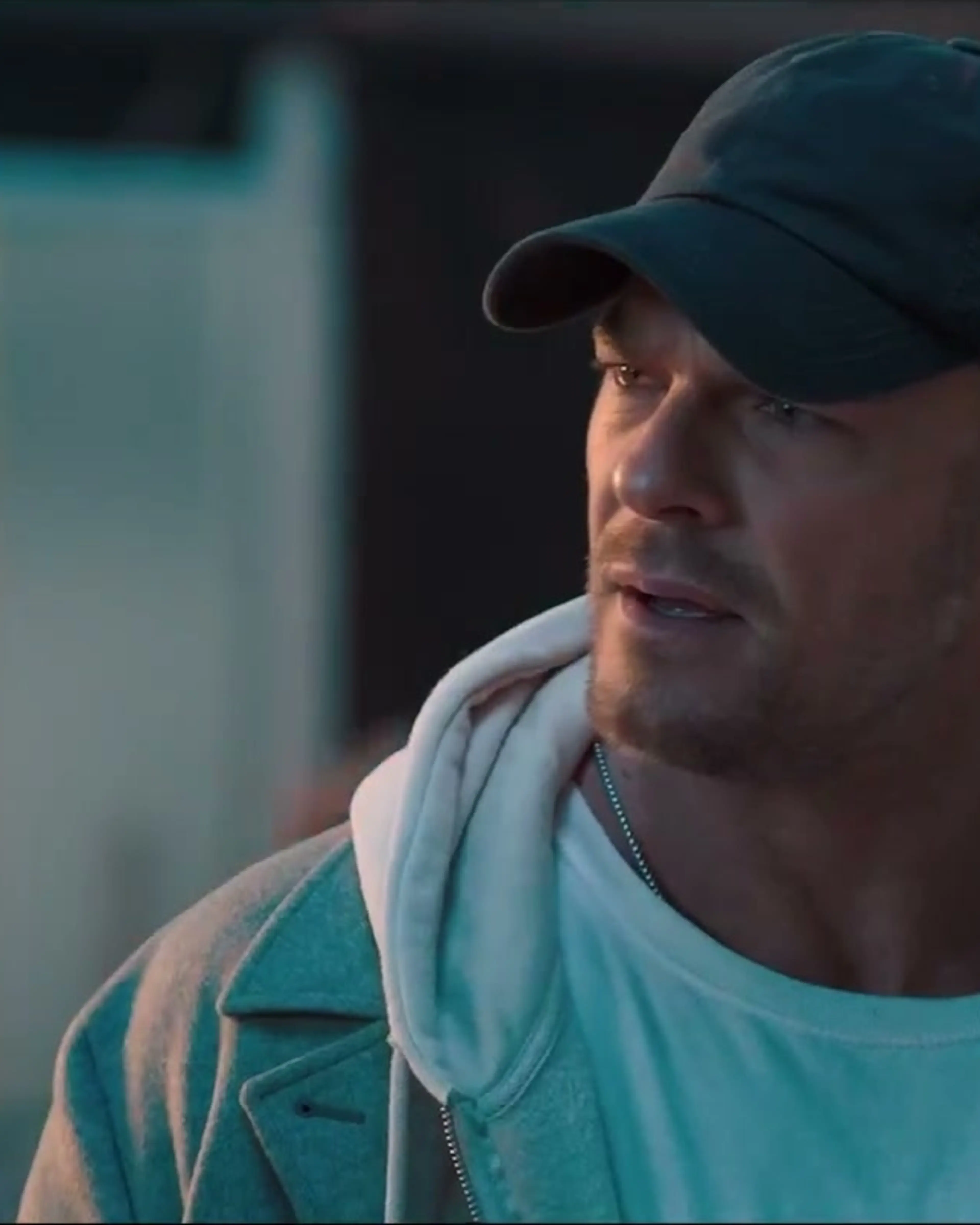Alan Ritchson’s thief, wearing a dark cap, looks ahead in the teaser.