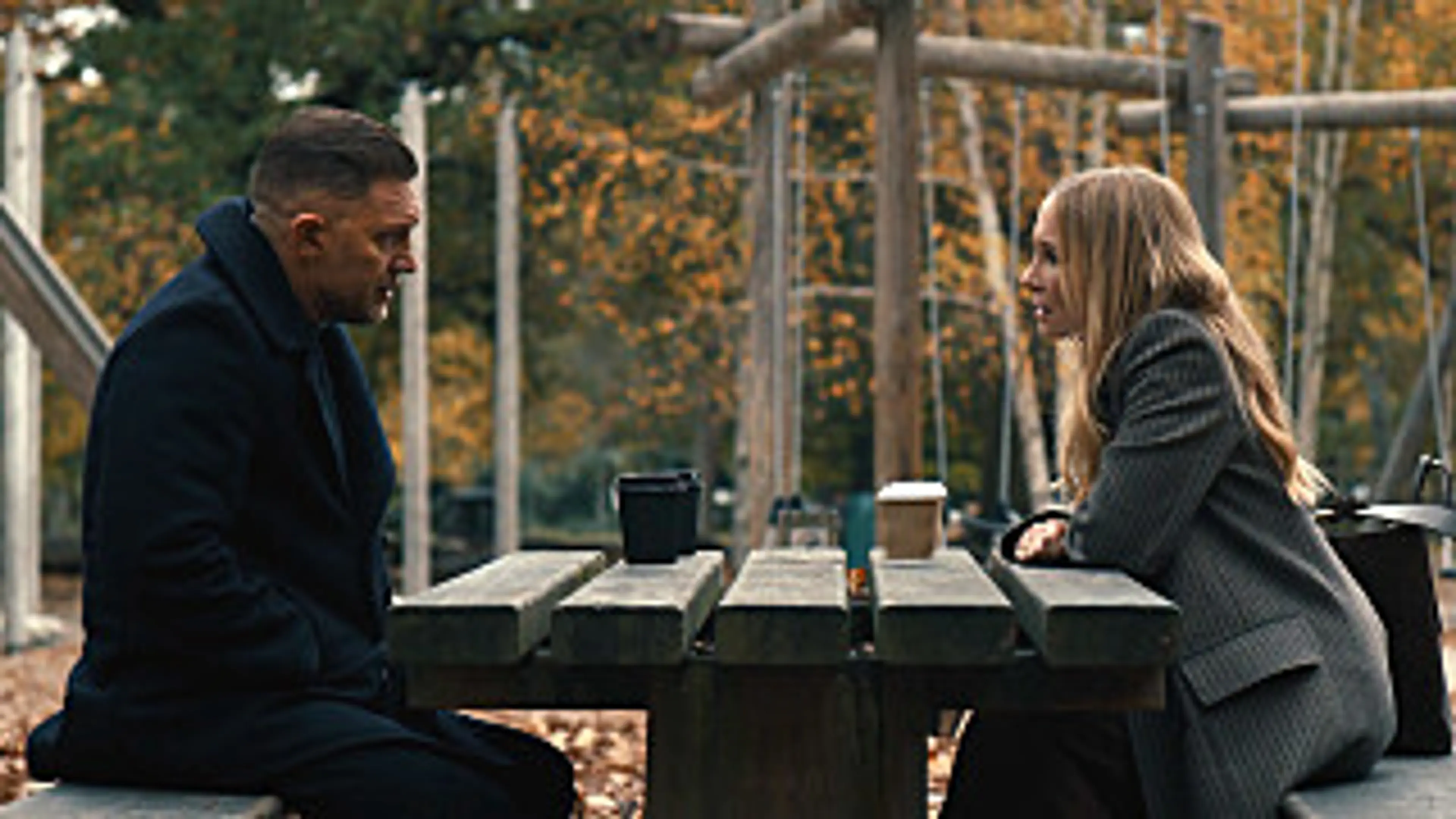 Tom Hardy as Harry Da Souza speaks with Joanne Froggatt in an official MobLand Season 2 still.