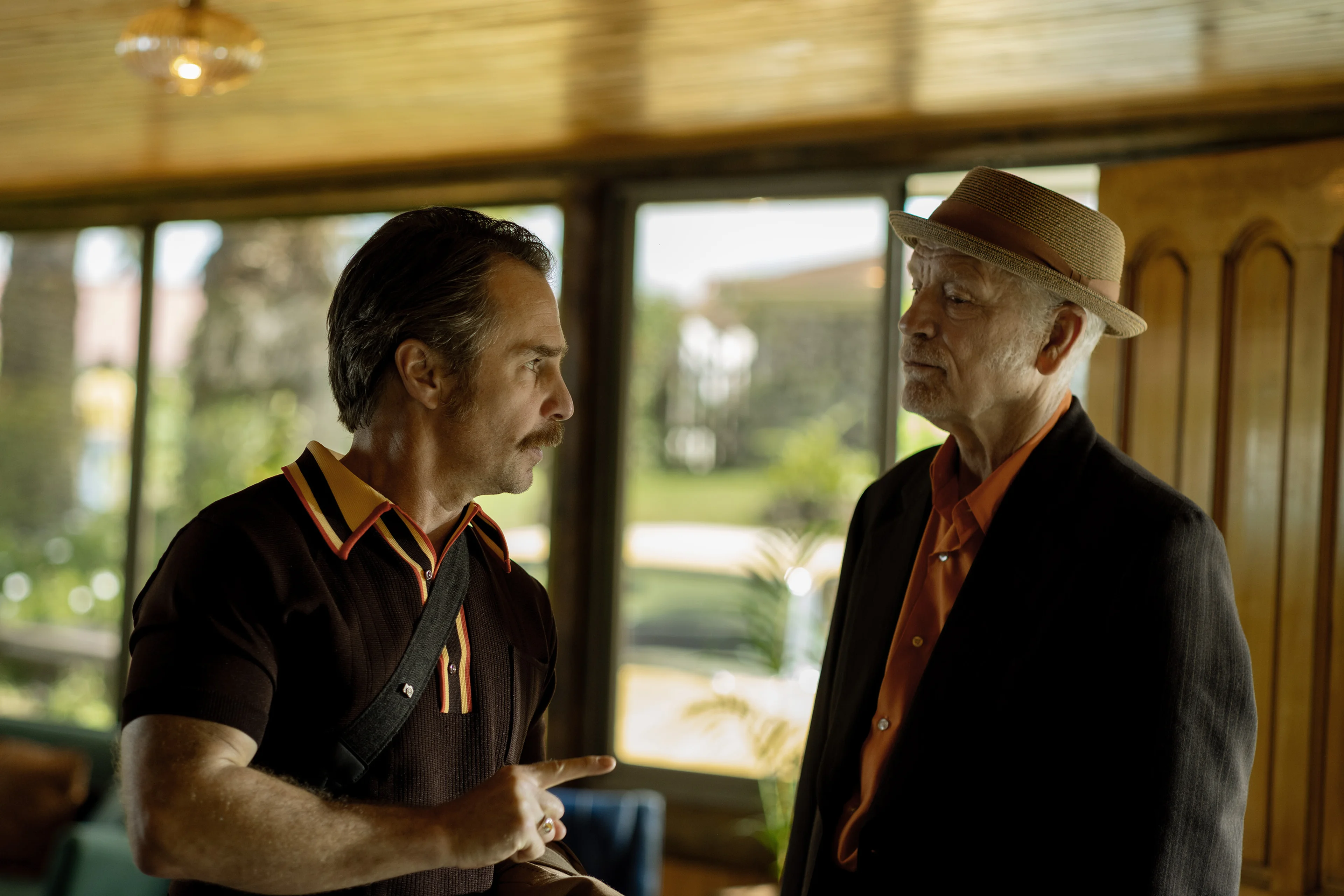 Sam Rockwell speaks to John Malkovich in a sunlit room in Wild Horse Nine.